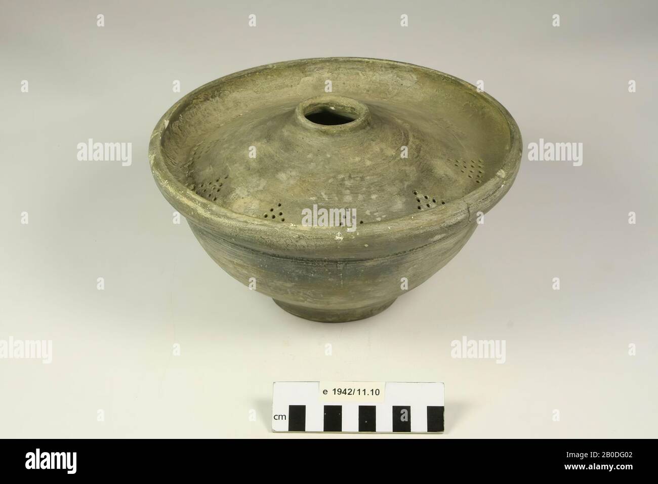 Plaster cast. The top of the object has holes in a triangle pattern ...