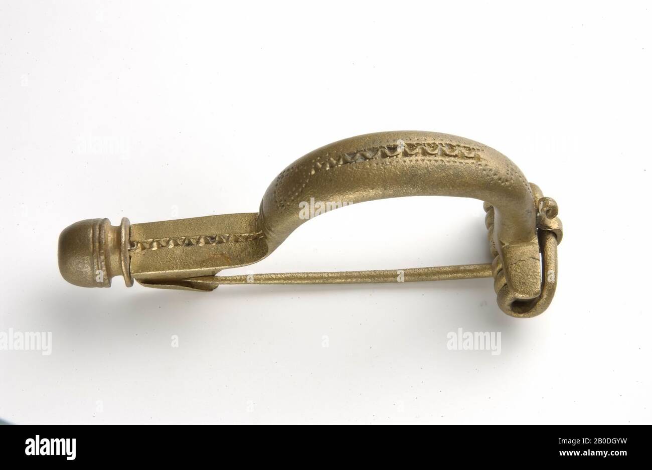 Bronze upper-arched fibula (Van Buchem 14Ca) with thick, almost round brace. With button on the foot (Haalebos type C). Bracket decorated with spirals and dot lines. Very cool. Böhme refers to Almgren 16., fibula, arch fibula, metal, bronze, length: 6,9 cm, width: 2,1 cm, height 3,0 cm, roman 41-150 AD, Netherlands, Gelderland, unknown, unknown, Maas or Waal Stock Photo