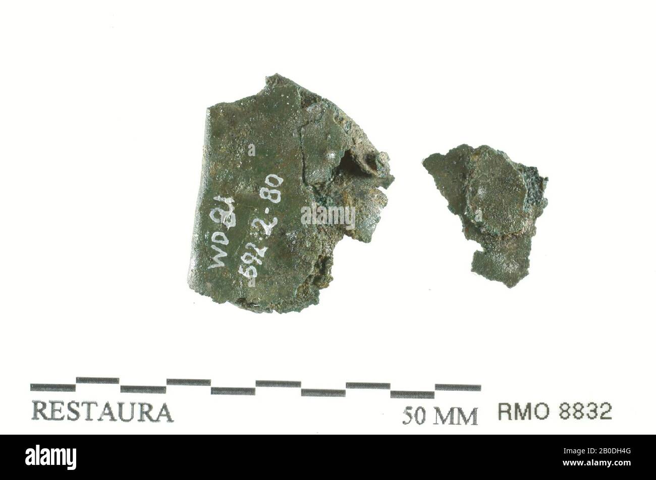 plate fragment, 2x, double folded, plate fragment, 2x, double folded, copper alloy, 2.6 x 2.1 cm Stock Photo