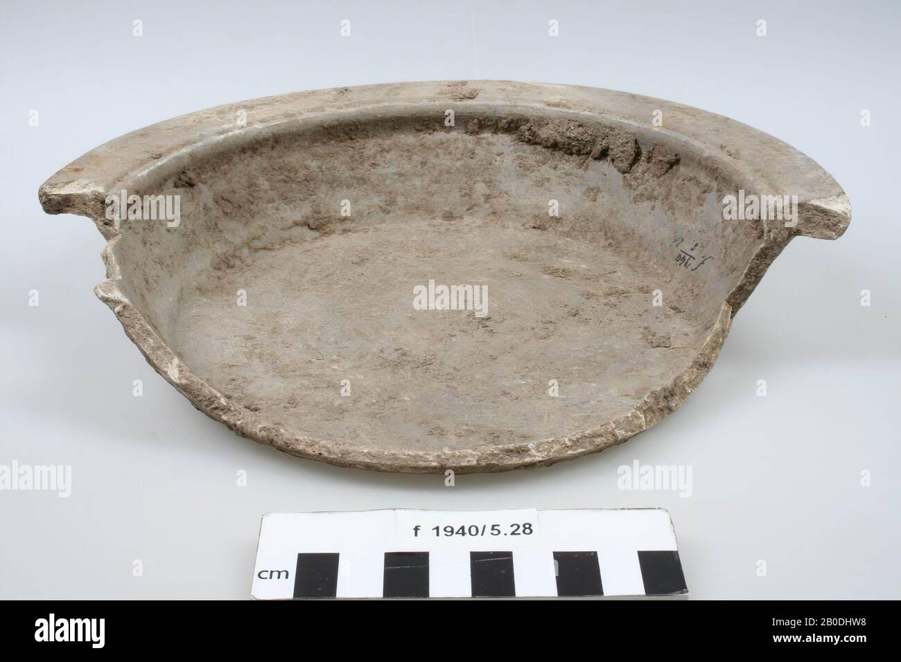 Plate of rough-walled earthenware. Half of the edge Stock Photo
