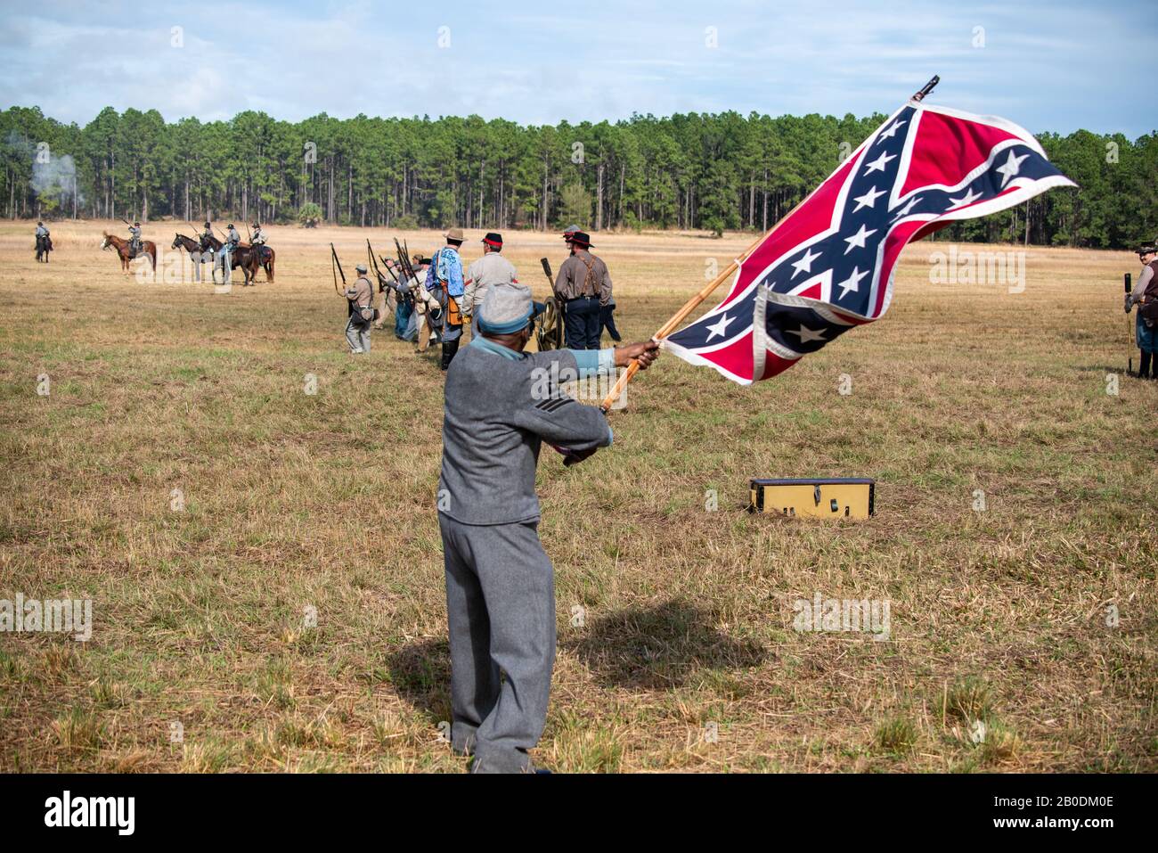 Brooksville, FL - January 19, 2020: An African-American Civil War Reenactor waves a large confederate flag at the reenactment of the Brooksville Raid, Stock Photo