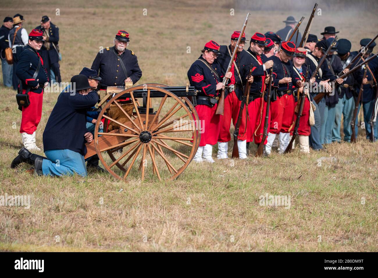 Brooksville, FL - January 19, 2020: Reenactors portraying Union troops at the time of the American Civil War prepare to fire a Gatling Gun. Stock Photo