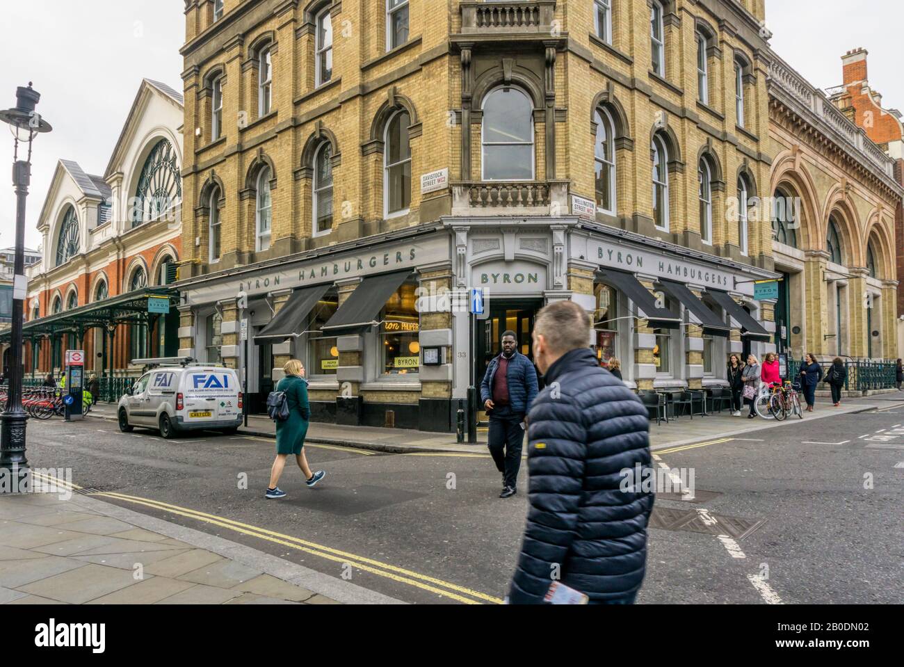 People walking past Byron Hamburgers in Covent Garden in central London. Stock Photo