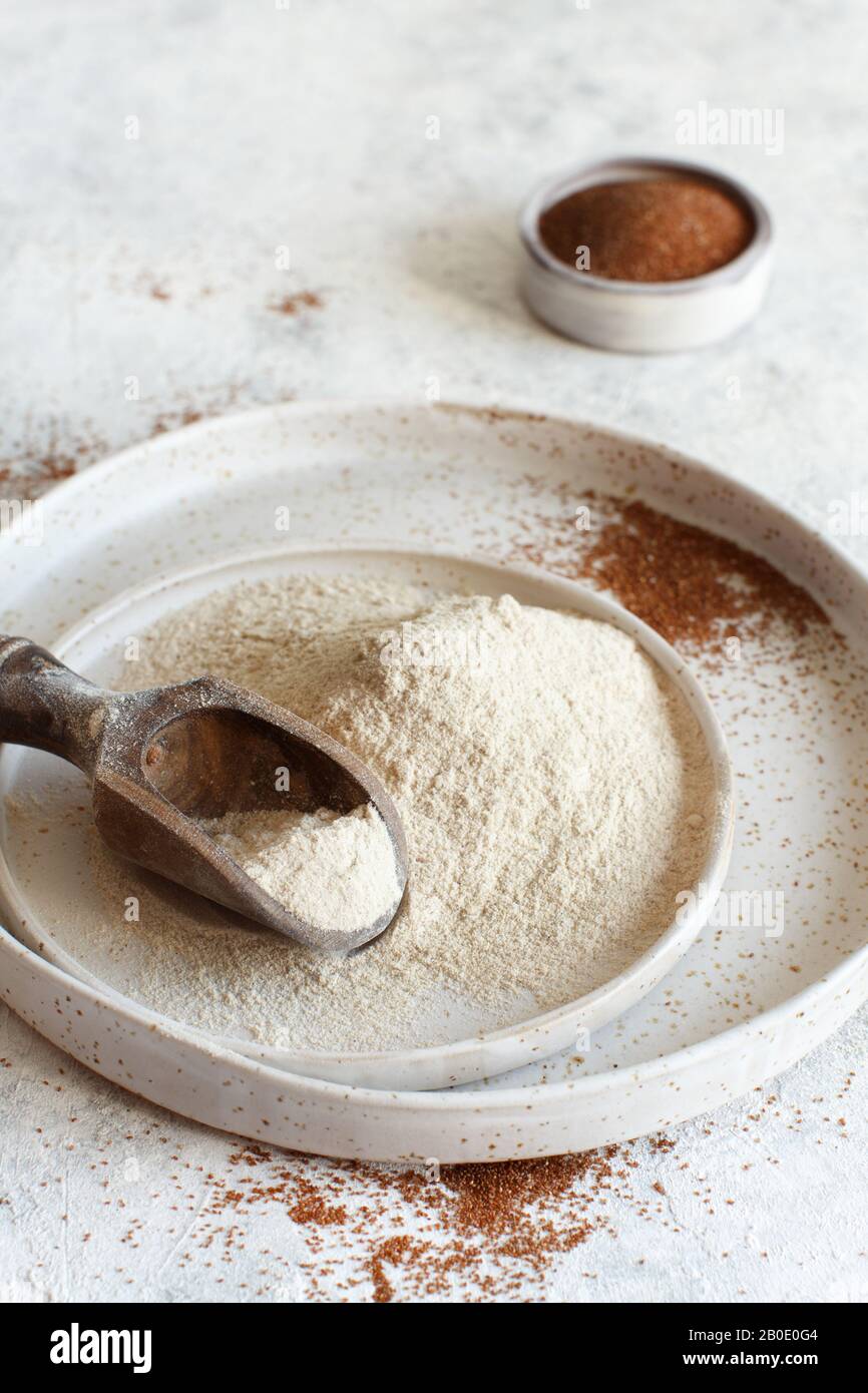 Teff flour on a plate and teff grain close up Stock Photo - Alamy