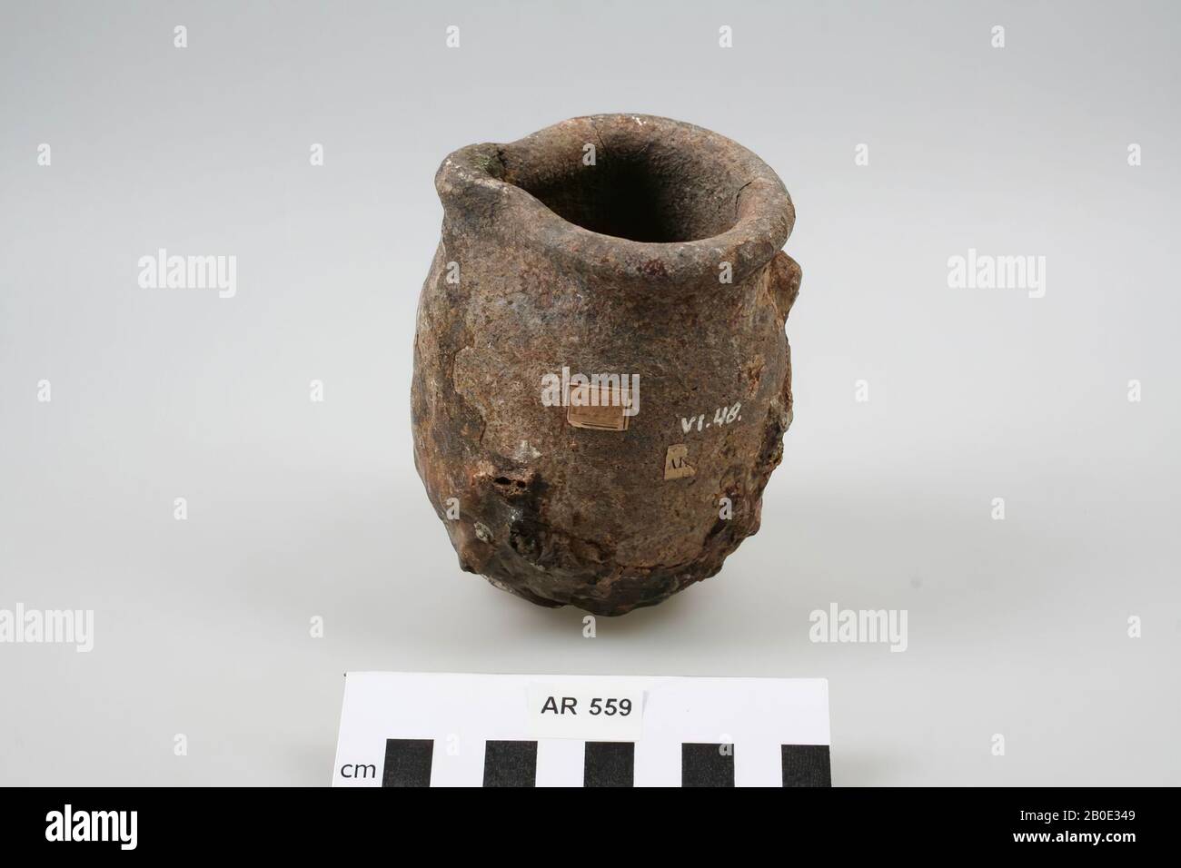 Jar of earthenware, used for metal casting, with baked glaze. 2 vertical cracks from the edge, remnants of metal at the bottom of the pot., Melting pot, earthenware, h: 11.9 cm, diam: 9 cm, roman, Netherlands, South Holland, Leidschendam-Voorburg, Voorburg, Arentsburg Stock Photo
