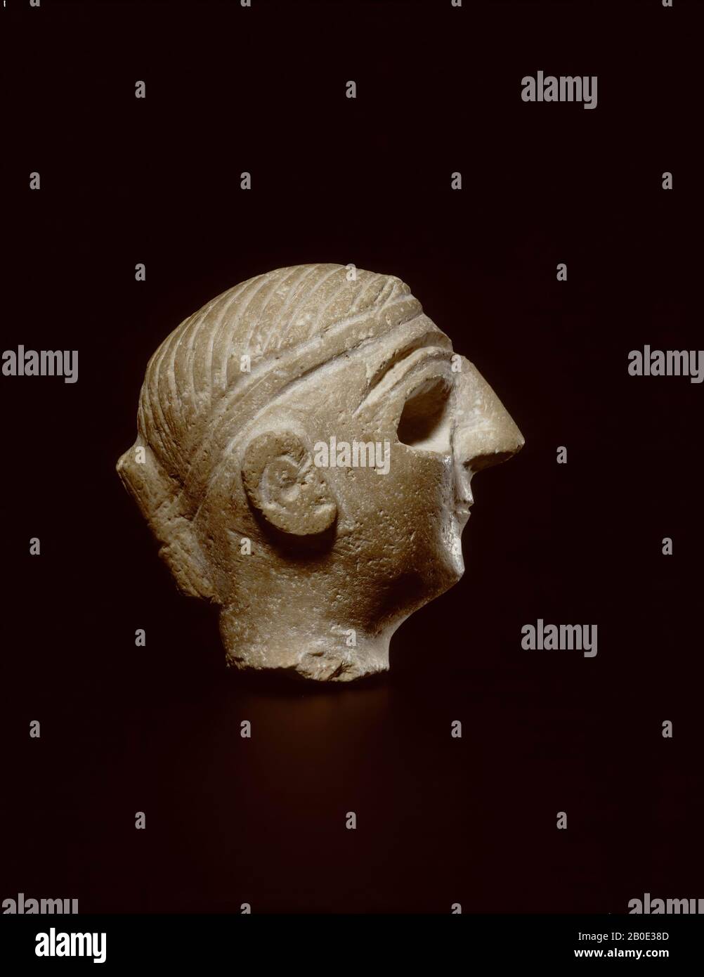 A woman's head of a cream-colored limestone, with a pointy nose. The eyes were originally inscribed., Sculpture, sculpture, stone, limestone, H 6.1 cm, L 5.5 cm, Early Bronze Age 2800 BC, Iraq Stock Photo