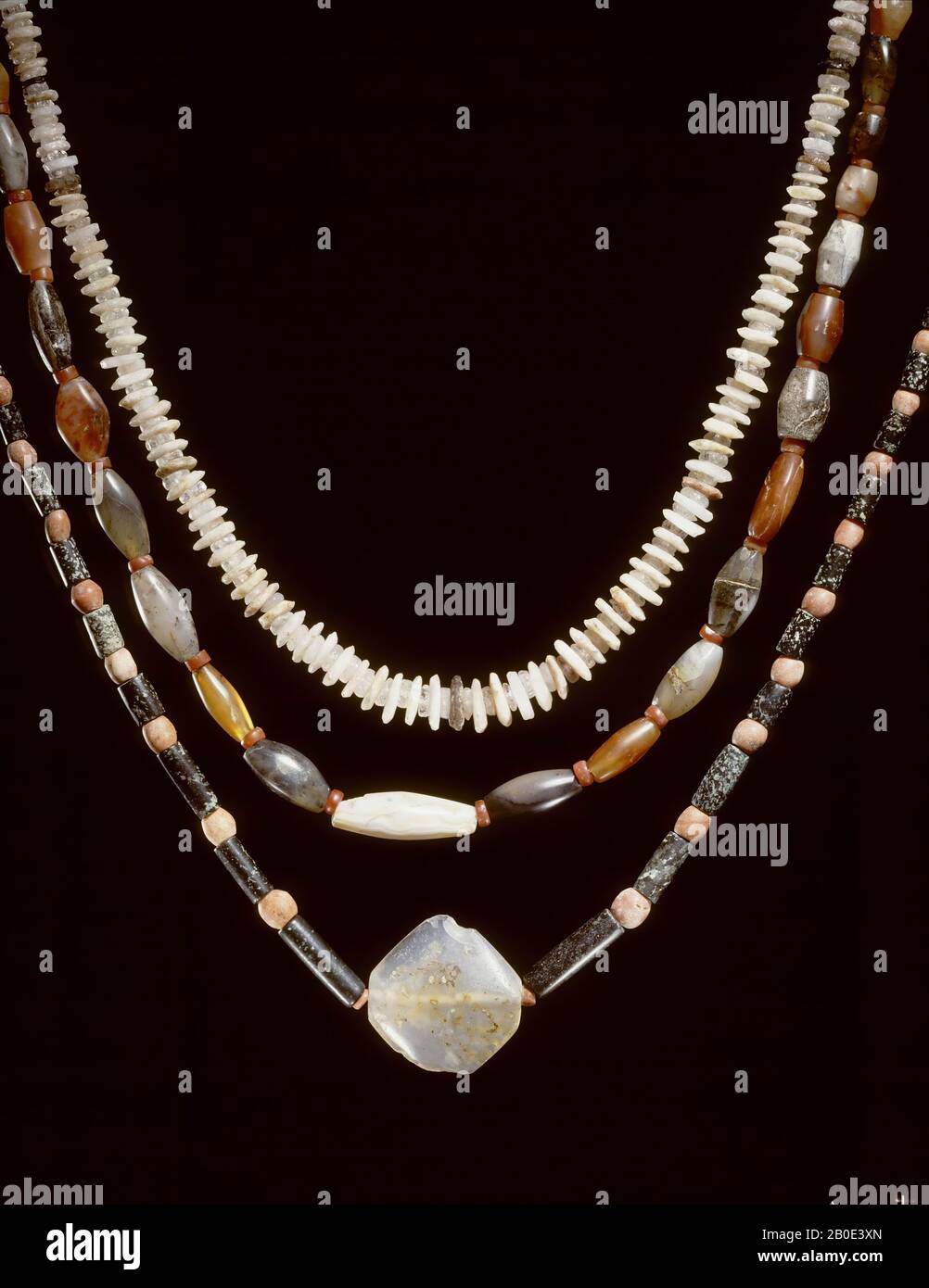A necklace consisting of 191 writing-like, flat-beaded beads of the same thickness. The beads have two forms: one with a constant diameter, the second with a diameter that increases towards the center of the chain. The first species, which acts as intermediate rings between the larger species, consists of transparent rock crystal, the second type consists of opaque crystal varieties in different pastel colors. Striking are two black (obsidian?) Beads and the large amber middle bead., Ornament, stone, rock crystal, crystal, obsidian ?, total length 51 cm, length folded 25 cm, width max. 1.7 cm Stock Photo