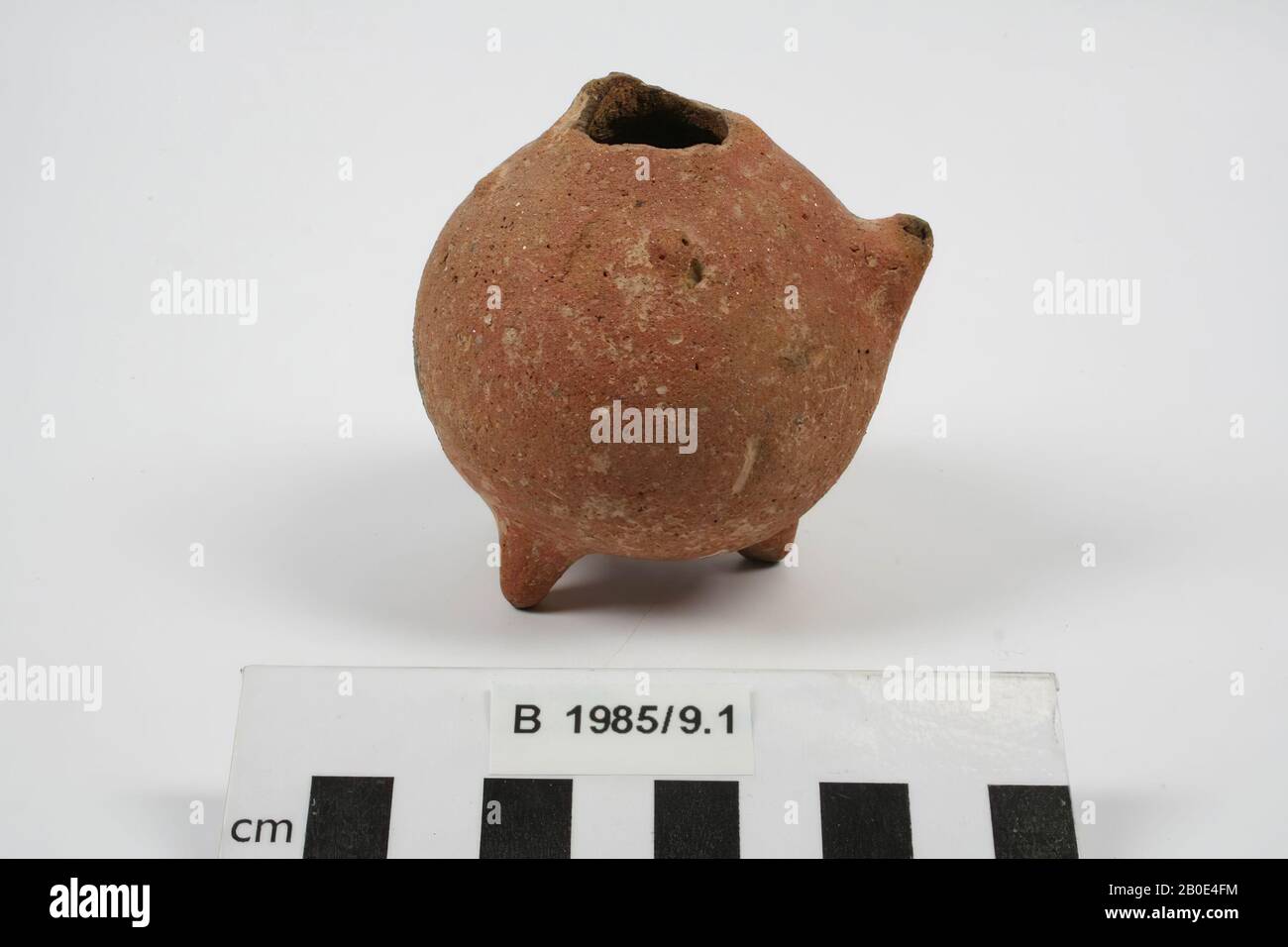 a small ball orange pot on three legs, with three nodules and protuberances., Crockery, pottery, H 8.2 cm, D 7.4 cm, Early Bronze Age 2800-2500 BC, Turkey Stock Photo