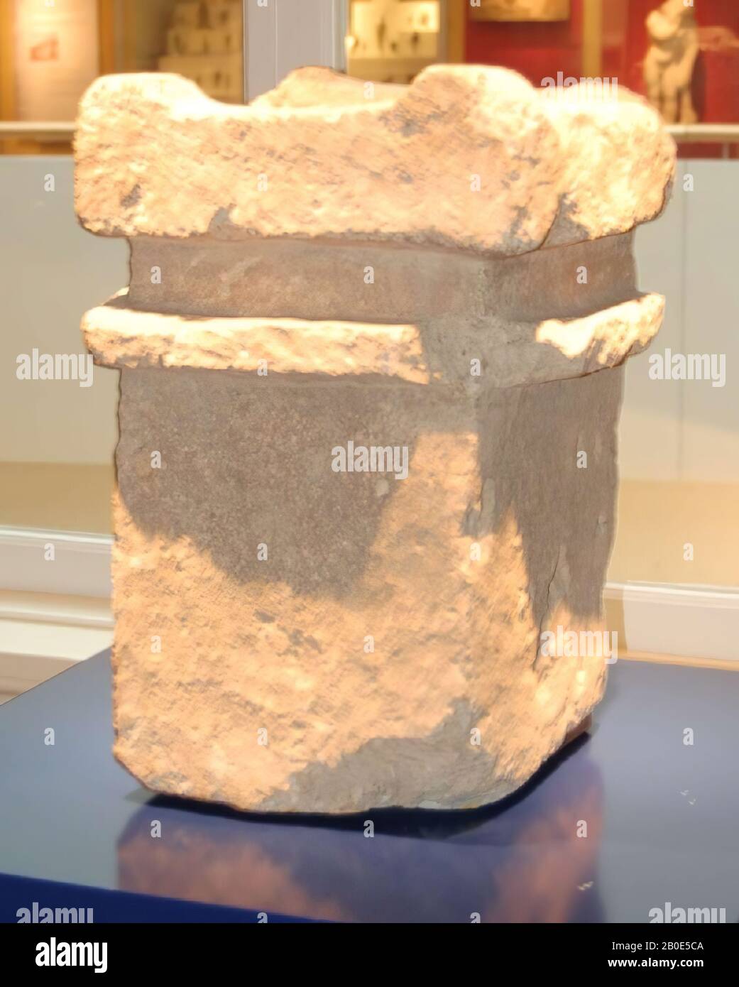 A rectangular altar with a hollow in the top. Around the hollow are