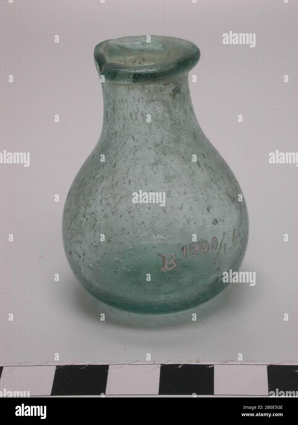 Spherical bottle of light green glass with a narrow neck and opening