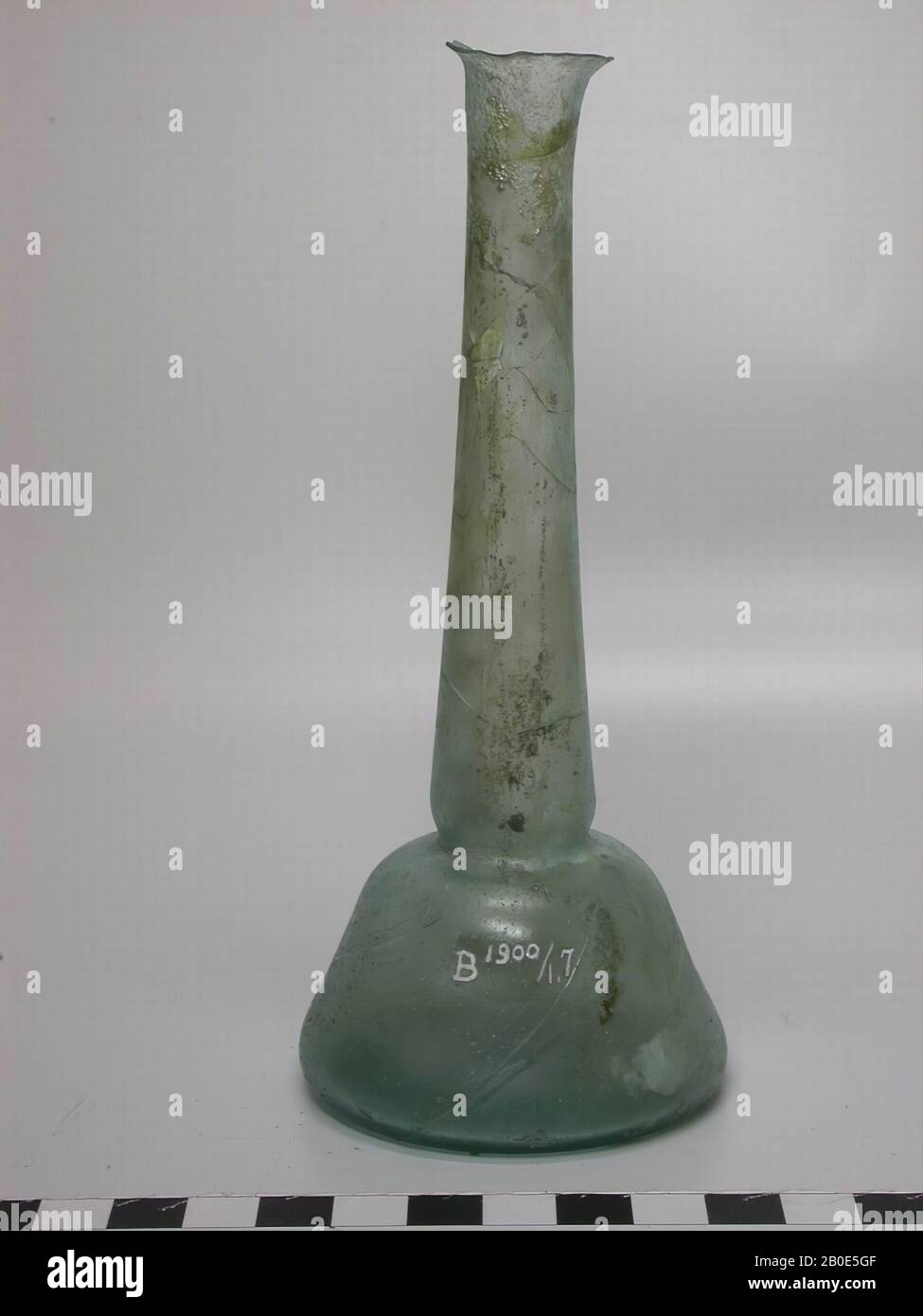 Bottle of light green glass with flat bottom, conical body and a long