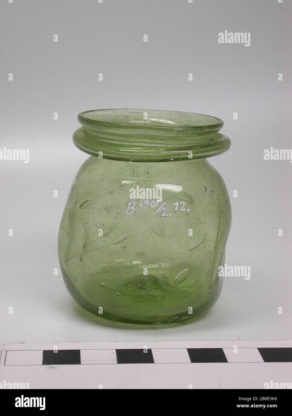 https://c8.alamy.com/comp/2B0E5K6/spherical-pot-of-green-glass-with-short-neck-and-flat-bottom-the-belly-is-decorated-with-indentations-tableware-glass-h-6-cm-lebanon-2B0E5K6.jpg