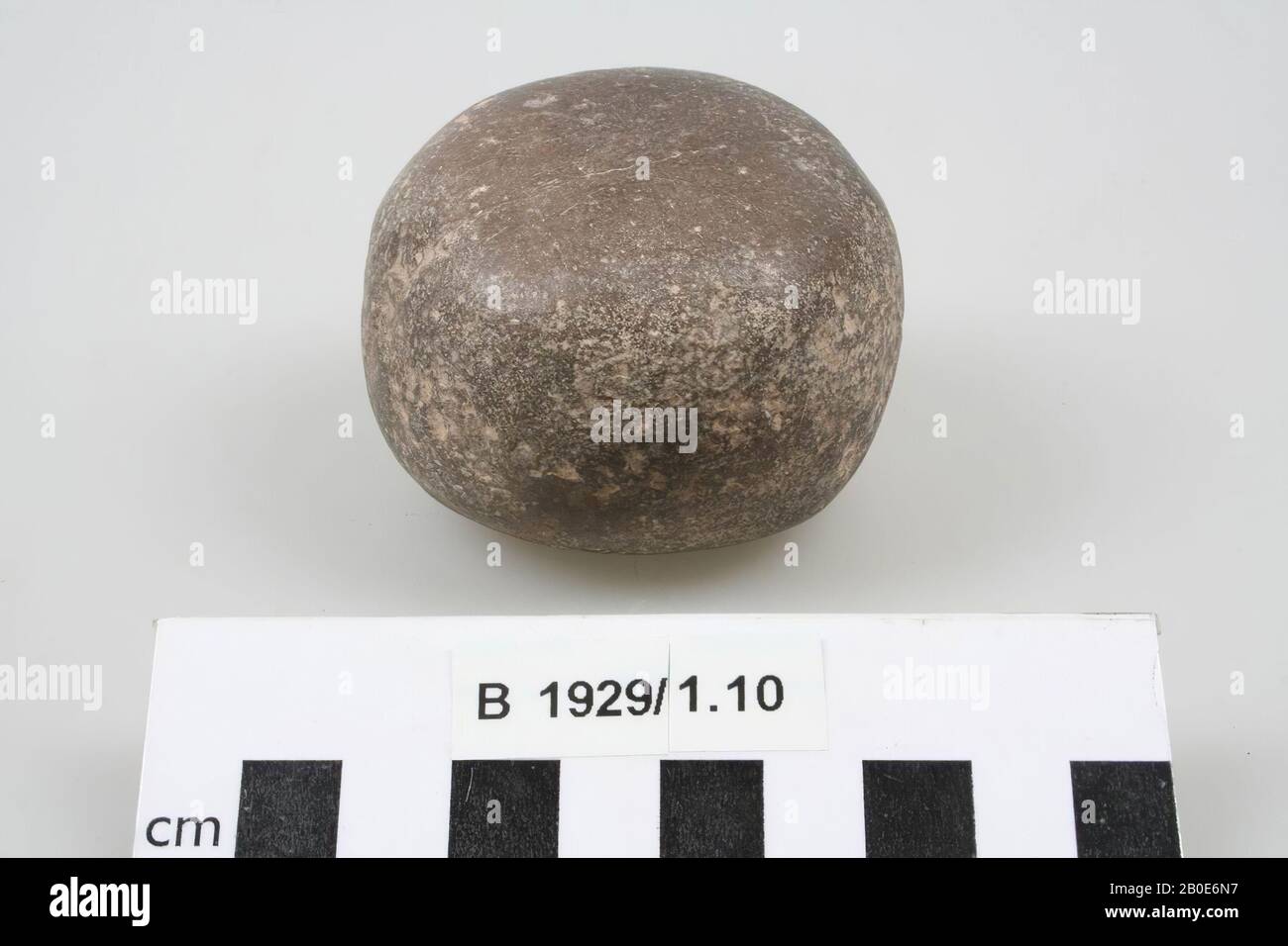 A barrel shaped quartzite or limestone stone, grindstone, stone