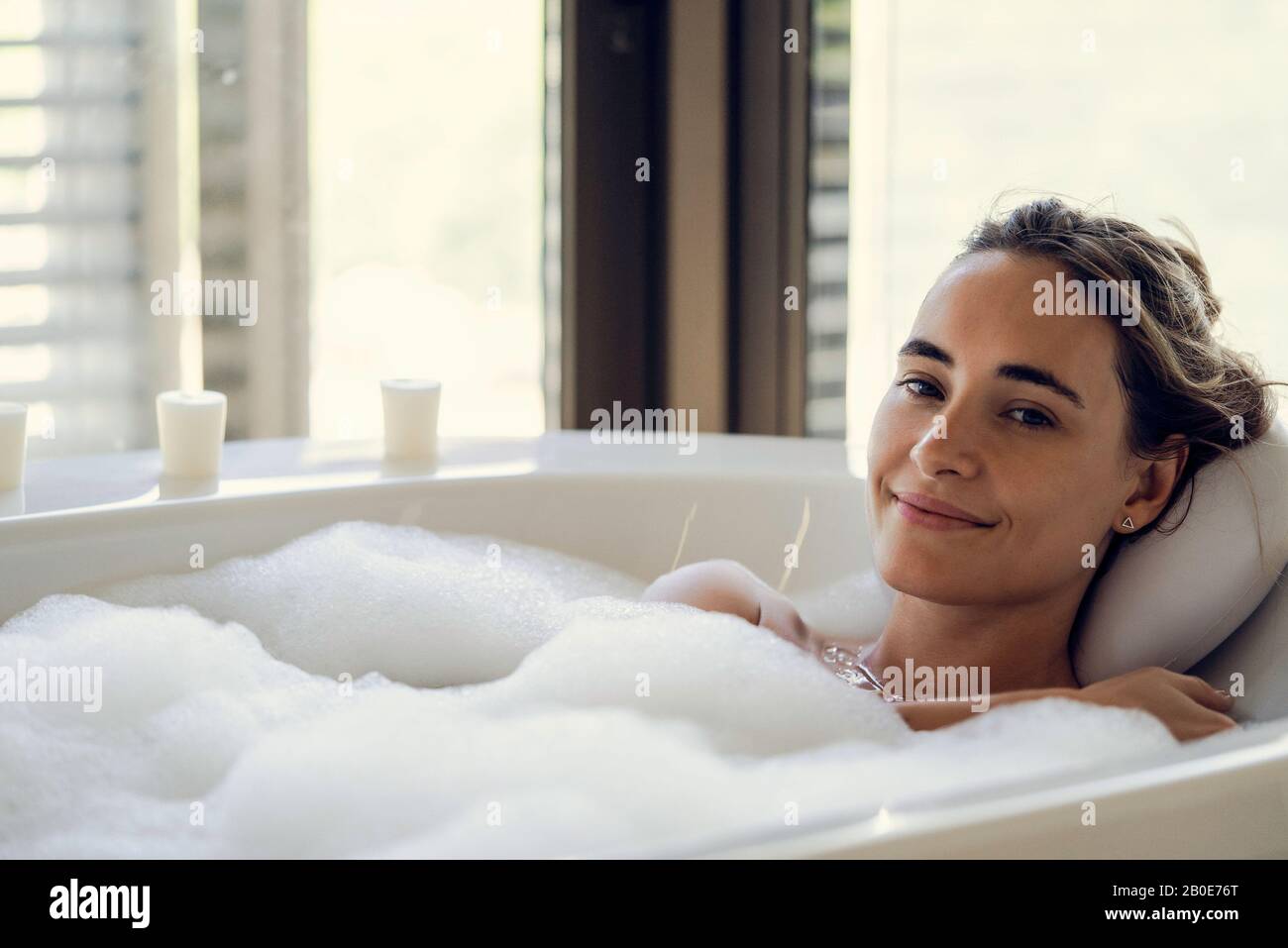 Young woman relaxing in bathtub Stock Photo