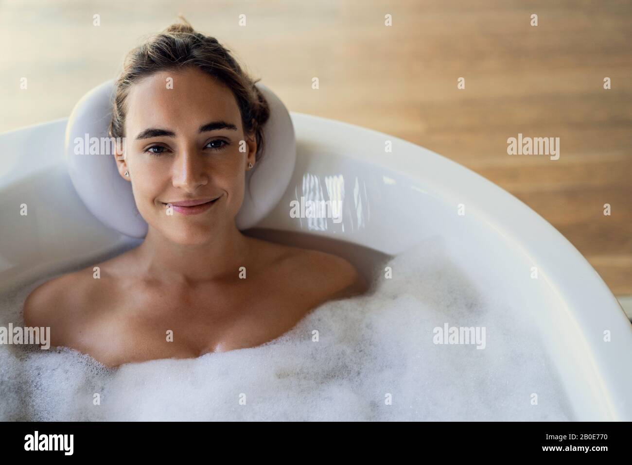 Young woman relaxing in bathtub Stock Photo
