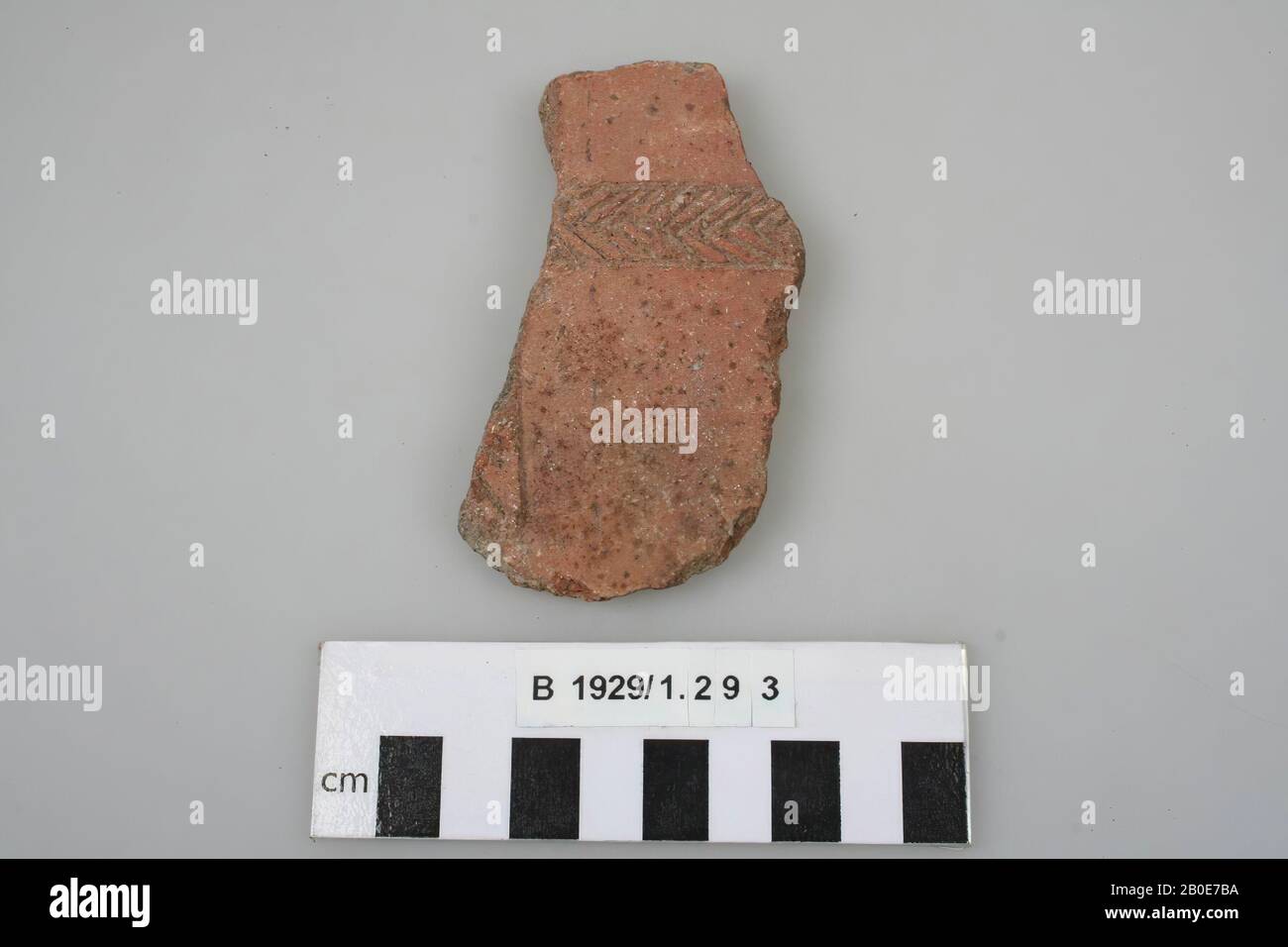 A wall shard, decorated with vertical and horizontal bands with notches ...