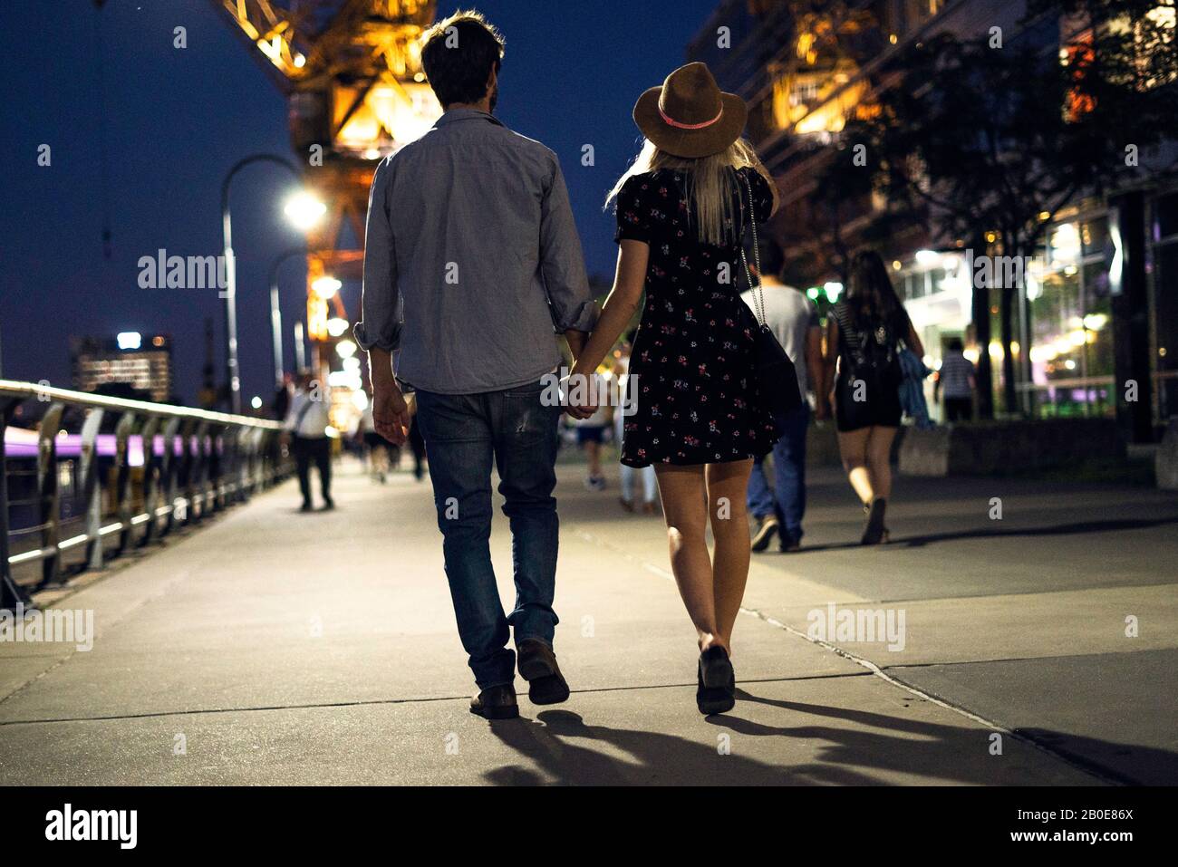 Couple walking on street at night Stock Photo Alamy