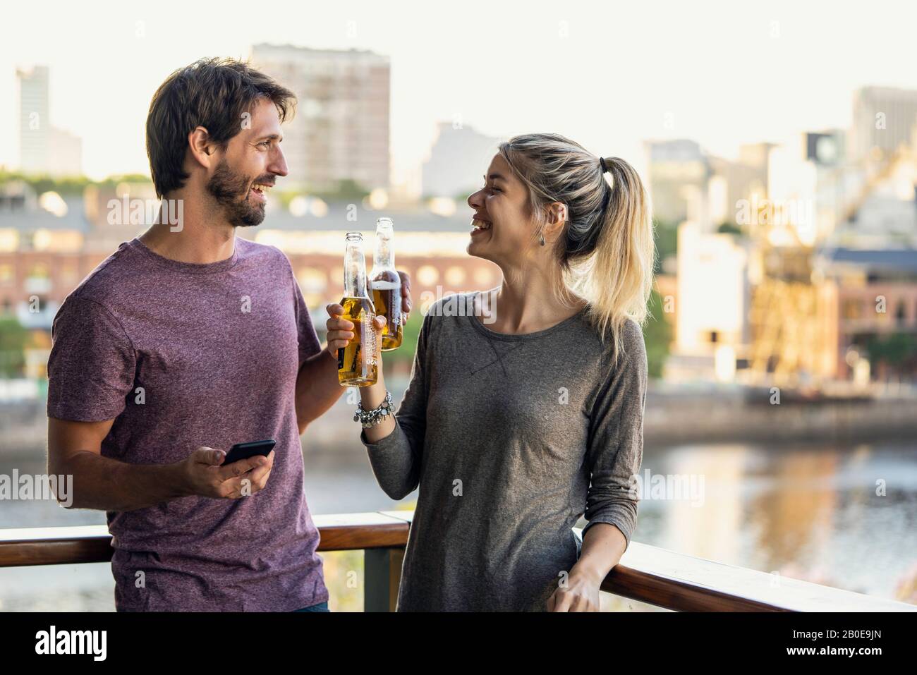 Young couple standing on balcony Stock Photo