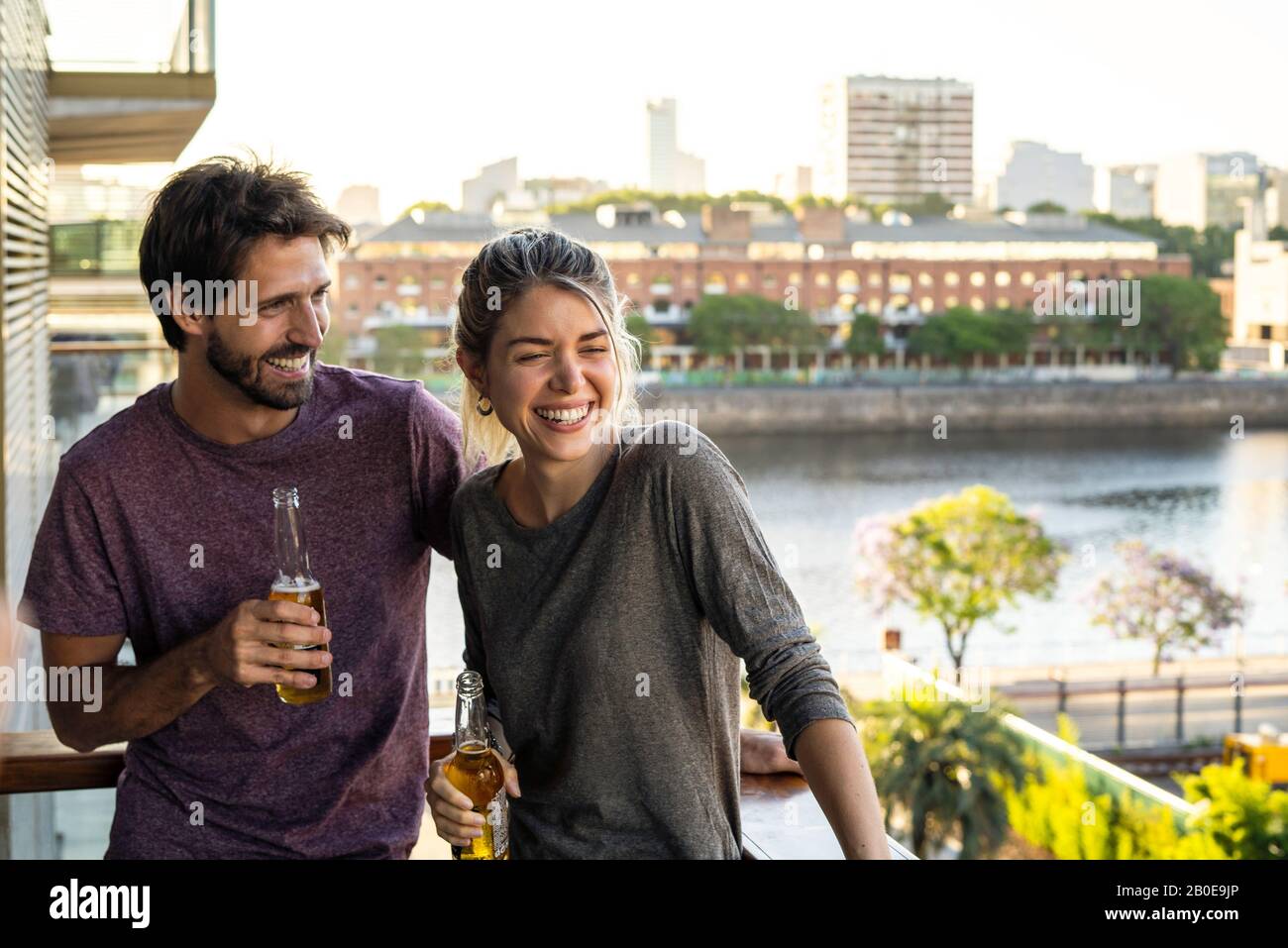 Young couple standing on balcony Stock Photo