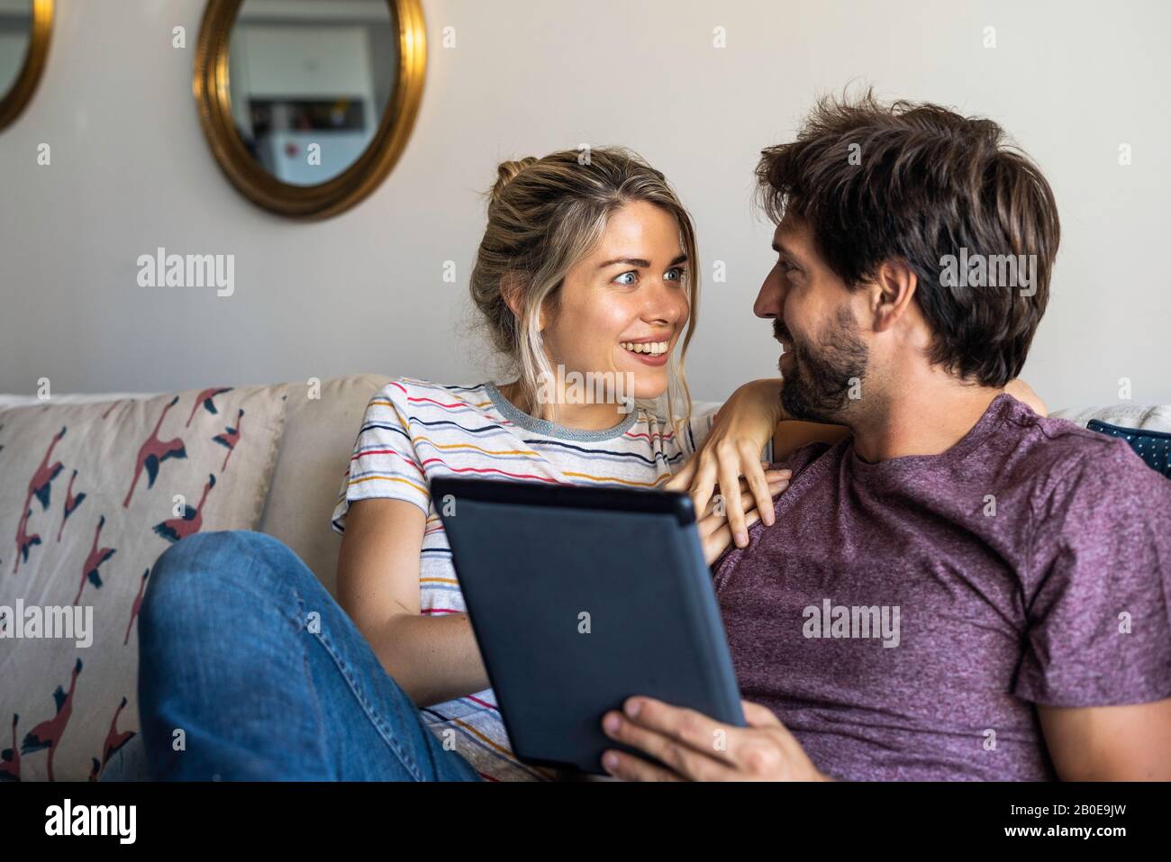 Couple using digital tablet at home Stock Photo