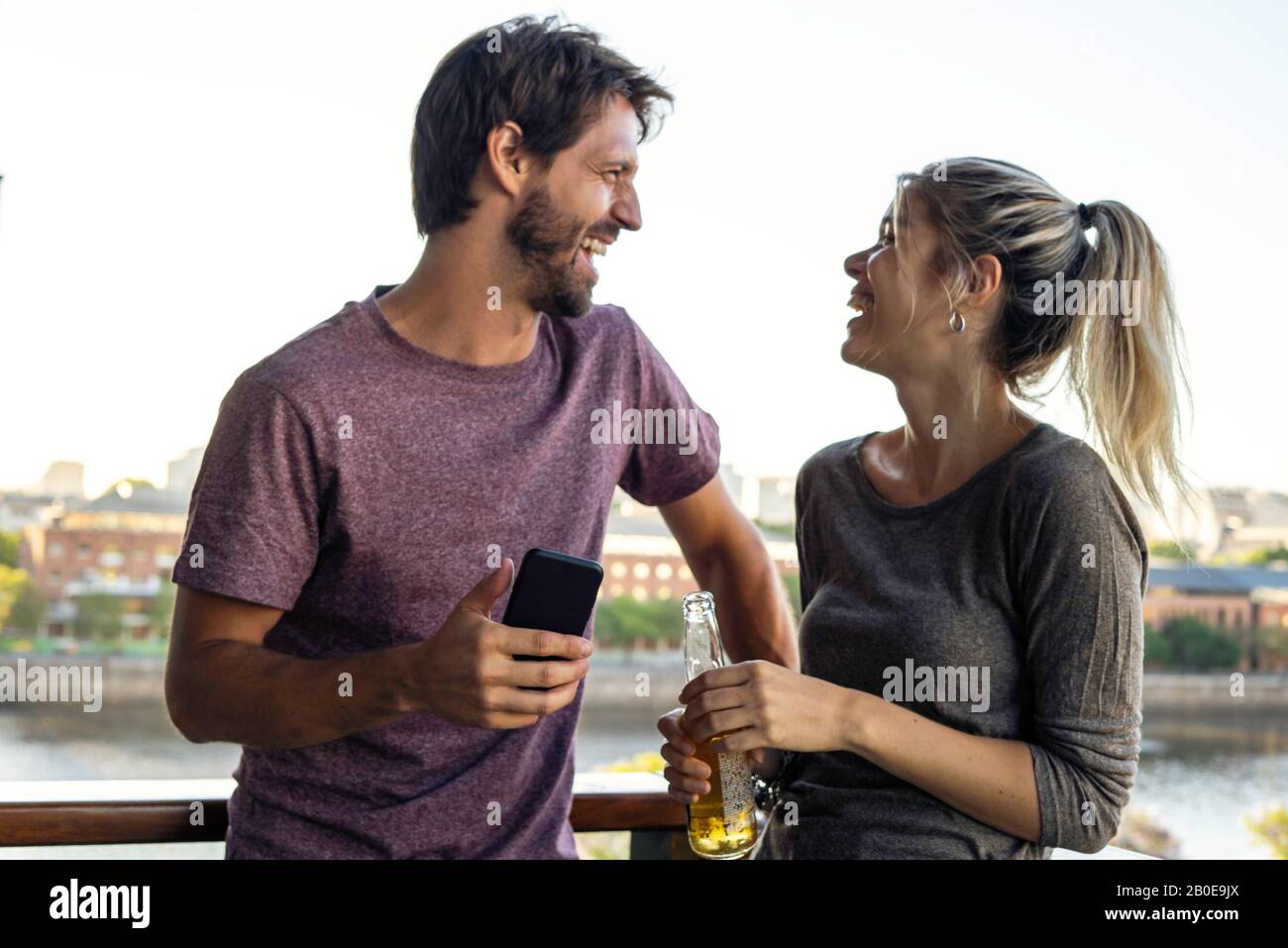Young couple standing on balcony Stock Photo