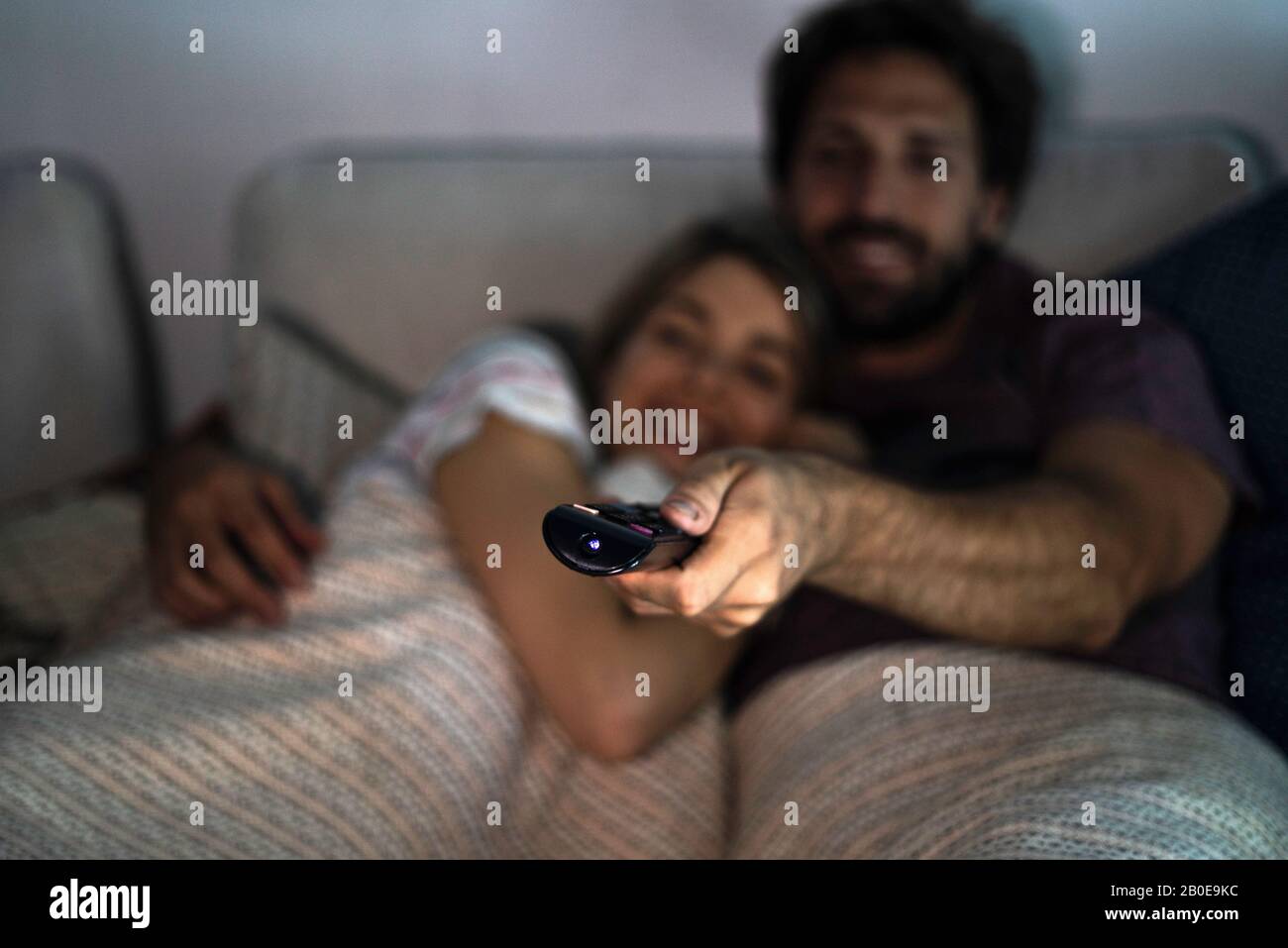 Close-up of man's hand operating remote control Stock Photo