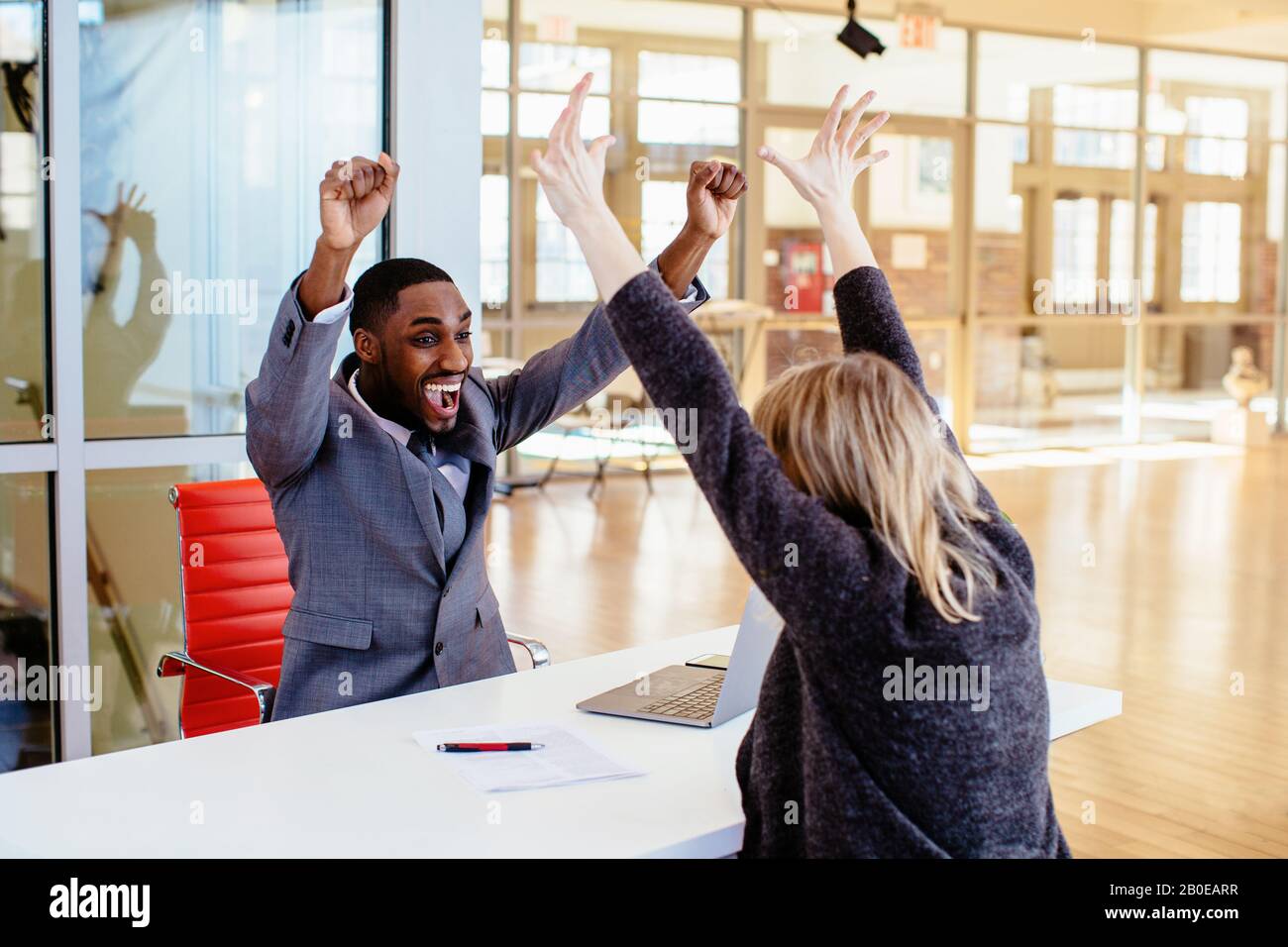 Portrait of a happy smiling young man in business suit with woman ...