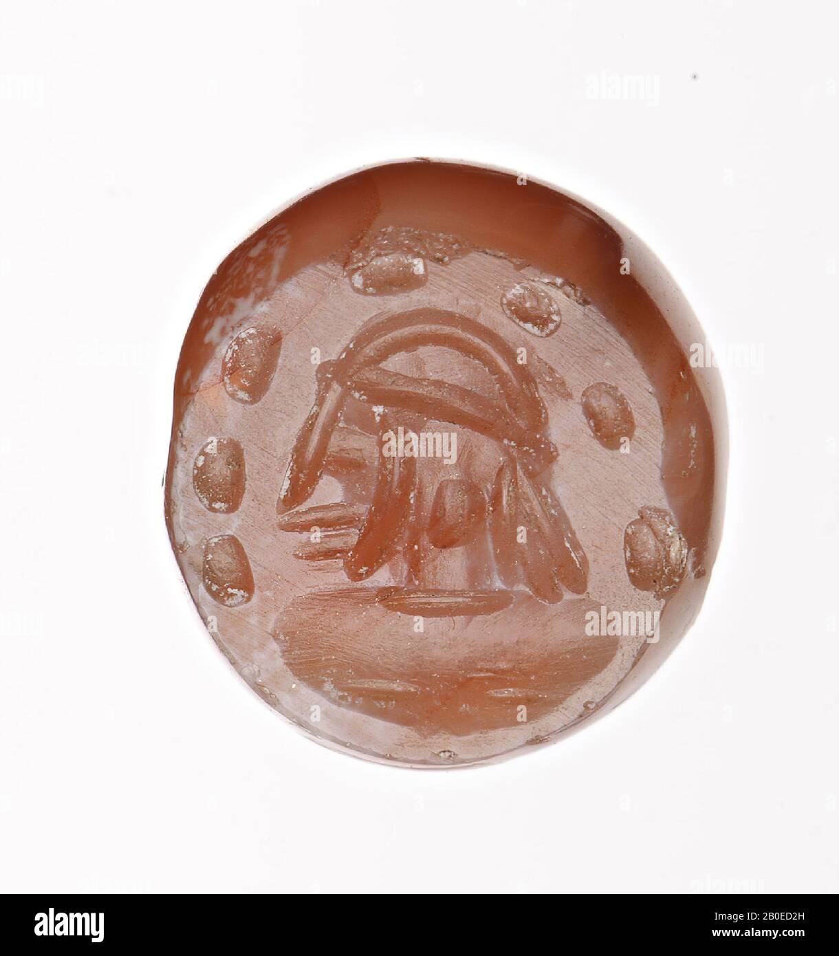 A dome-shaped stamp with an image of a male head with a hat, surrounded by 7 dots., Seal, stone, carnelian, D 1 cm, H 0.9 cm, D hole 0.1 cm, Iran Stock Photo
