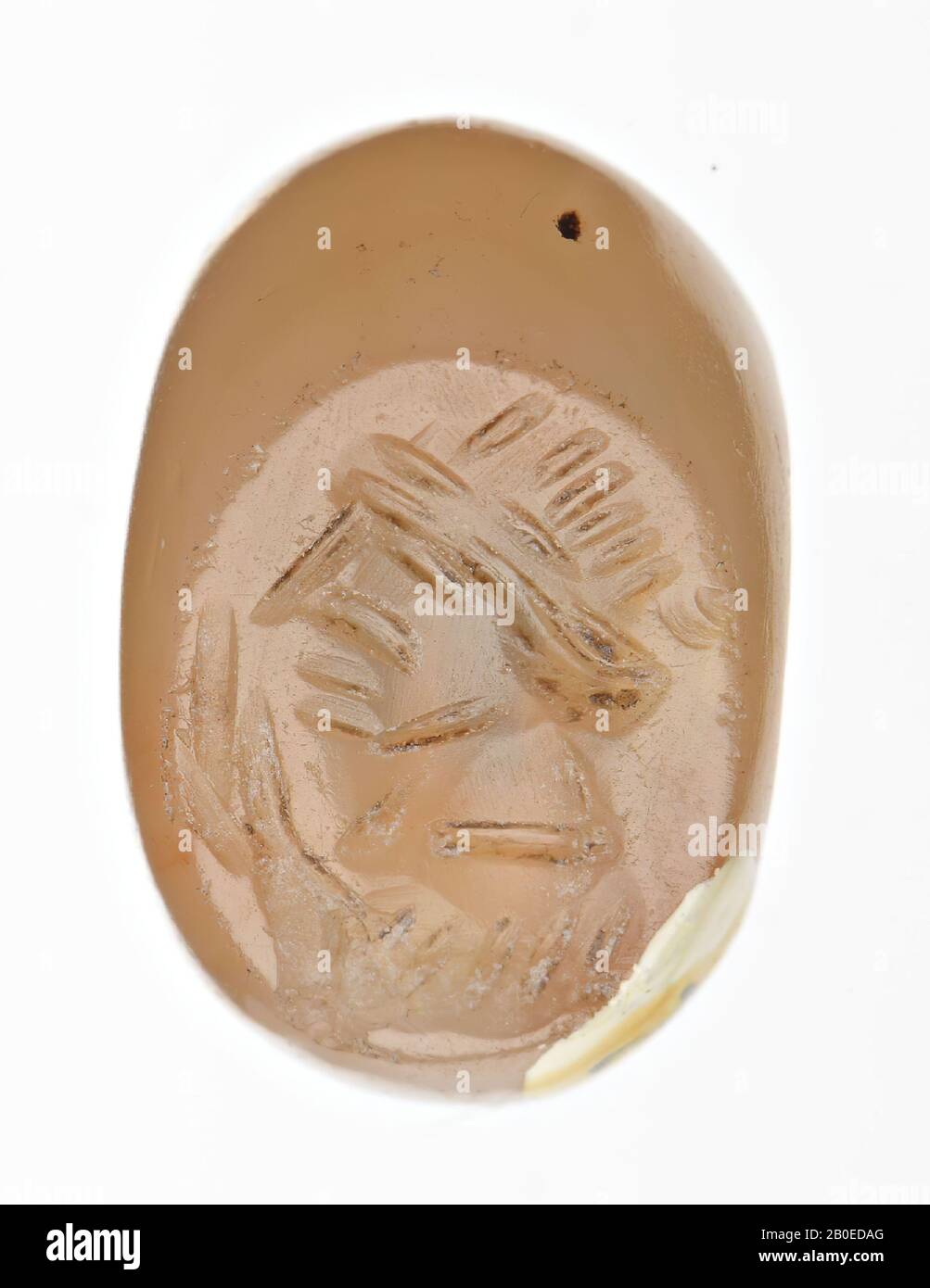 An ellipsoid stamp with an image of the face of a man., Seal, stone, carnelian, D 1.1 cm, H 0.8 cm, D hole 0.5 cm, Iran Stock Photo