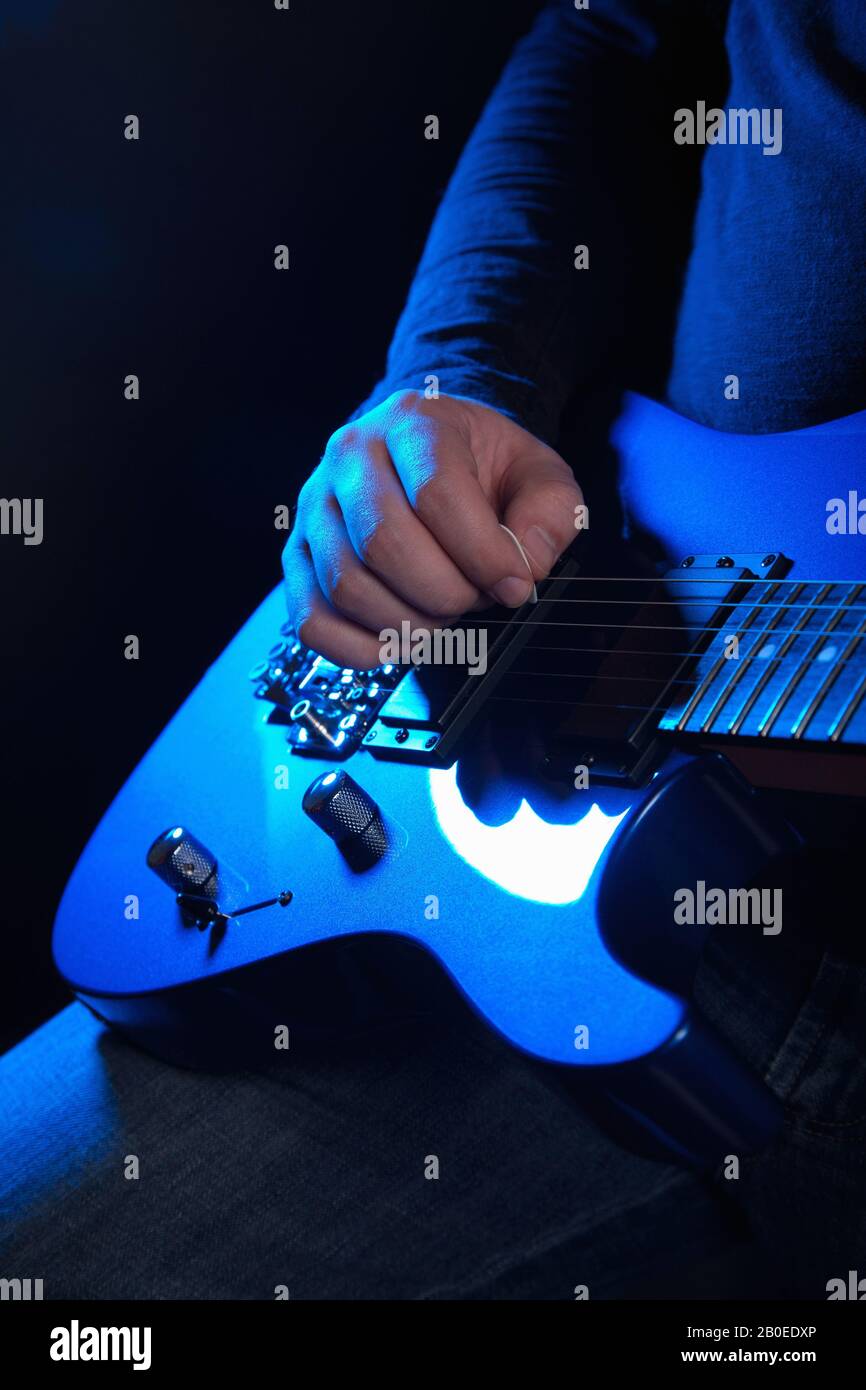 Musician Rock Guitarist Playing A Blue Guitar Stock Photo Alamy musician-rock-guitarist-playing-a-blue-guitar-stock-photo-alamy