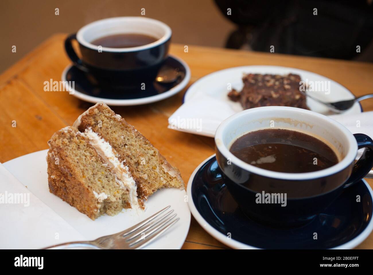 Coffee and cake on a table in a cafe in the UK Stock Photo