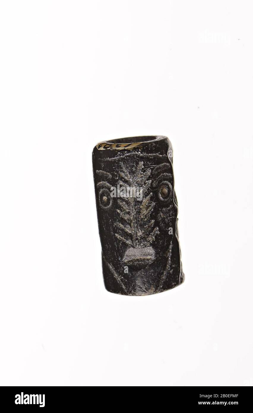 A stone cylinder stamp with an image of two standing people. It is a sacrificial scene., Seal, stone, H 1.6 cm, D 0.9 cm, Iran Stock Photo