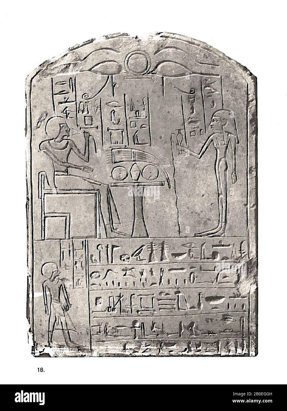 Penserd, round arch, Limestone stele of a king writer named Penserd. In the round arch two Horus eyes with a ring in between. The inscription contains sacrificial formulas for the god Osiris. Penserd is pictured sitting on a chair at an offering table while he smells a lotus flower. For the Egyptians, the lotus was a symbol for regeneration. His wife stands opposite Penserd. She pours out a liquid as an offering, this is called a libation. On the bottom left is Seni pictured, the brother of Penserd. He has founded this stela for Penserd, of course he shows himself on the stela. So he also Stock Photo