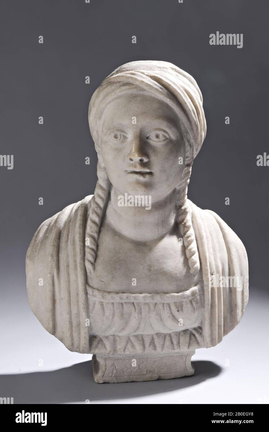Around the head is a turban-like cloth knotted. The hair hangs in two long staves at the front, far across the chest. A hor in the heavy neck. pleat. The robe has a square neckline above the bust. And pleated cloth The piece is not antique., Female bust, stone, marble, 38.5 cm Stock Photo
