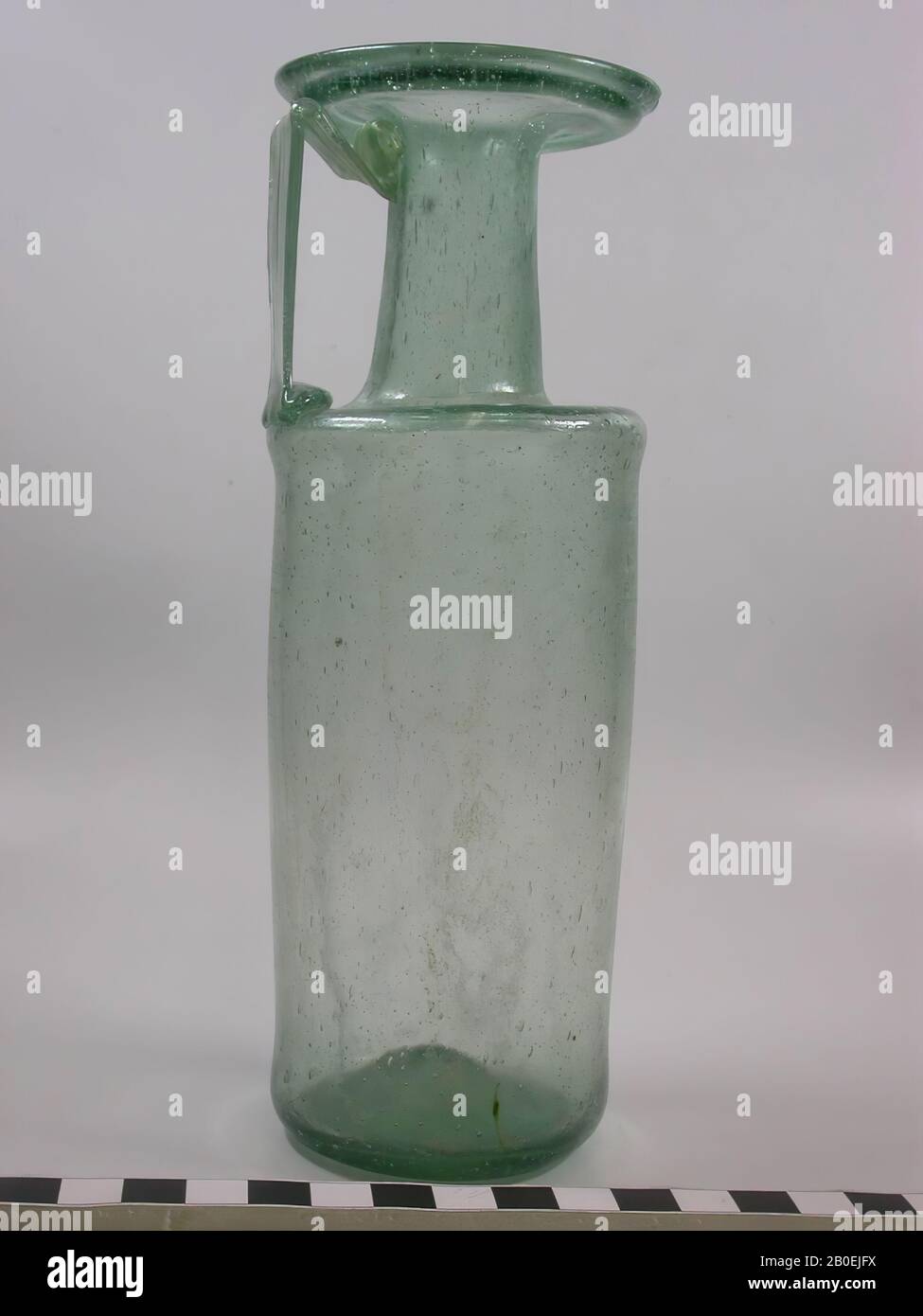 Cylindrical bottle of green glass with a straight shoulder, slightly neck narrowing towards the top, disc-shaped rim and band-shaped ear, can, glass, 19 cm, III (c) IV Stock Photo
