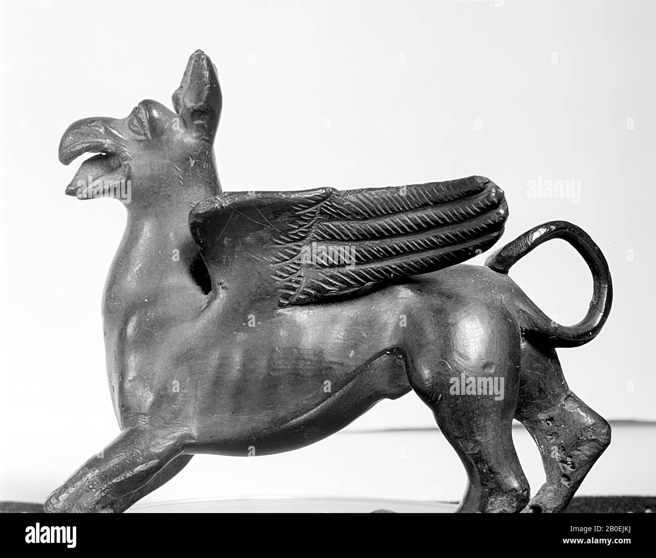 Griffin of Greek type with eagle's head, horse-tower, wide open mouth and a thick protruding tongue. Inscription: TINSCVIL, figurine, animal, mythical, griffin, bronze, 7,5 x 8,5 cm, transport size object (lxbxd) :, classic 500-400 BC, Italy, Italy Stock Photo