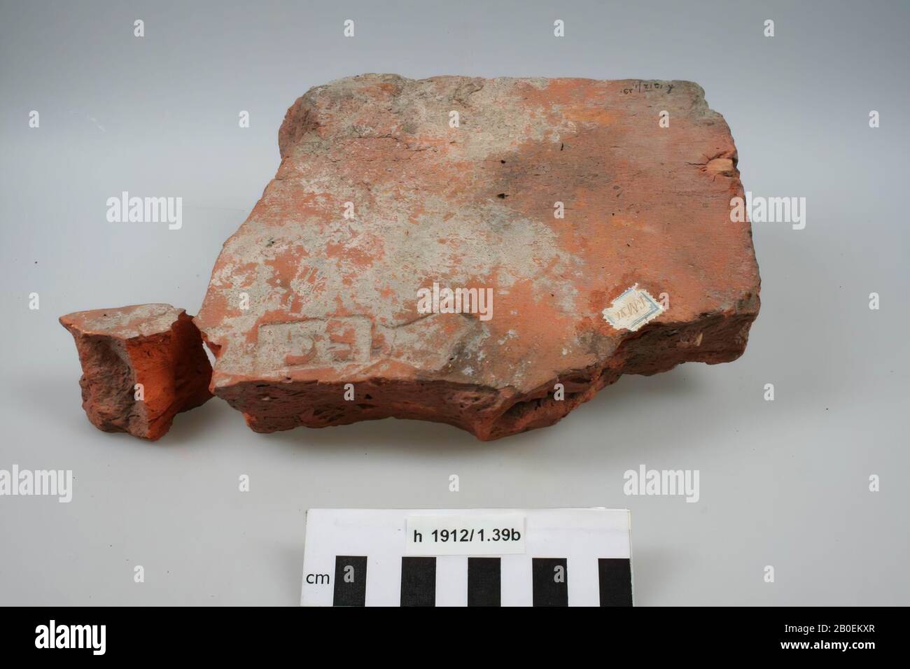 Fragment of a brick roof tile with stamp EC (letters lined up). A piece is demolished and attached separately., Roof tile (tegula), fragments, earthenware, brick, 20.5 x 15 x 4.3 cm, Roman 1-300, Netherlands, South Holland, Katwijk, Katwijk, Klein Duin Stock Photo