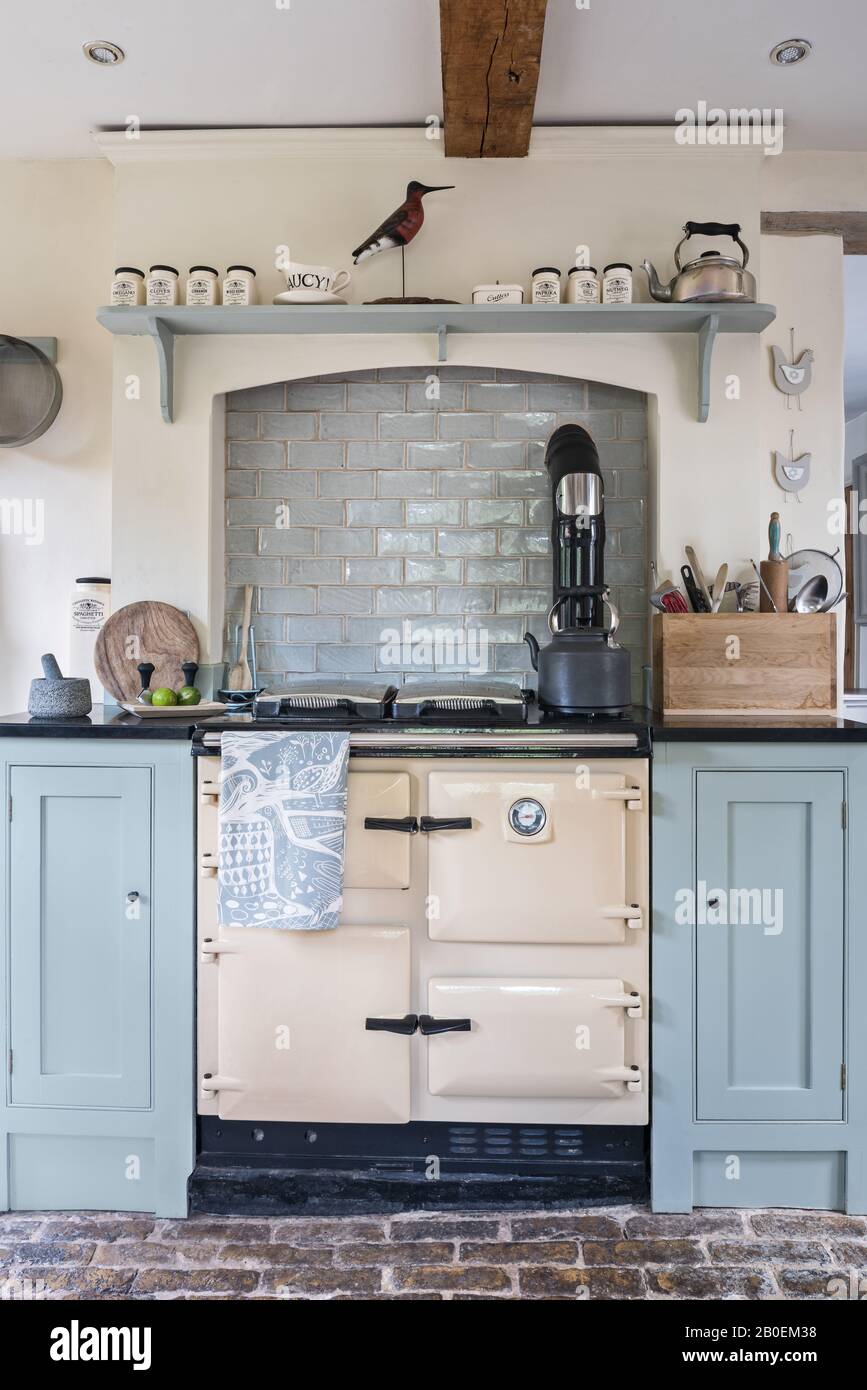 Rayburn in kitchen painted in Farrow & Ball’s Matchstick with original cobbled floor. Stock Photo