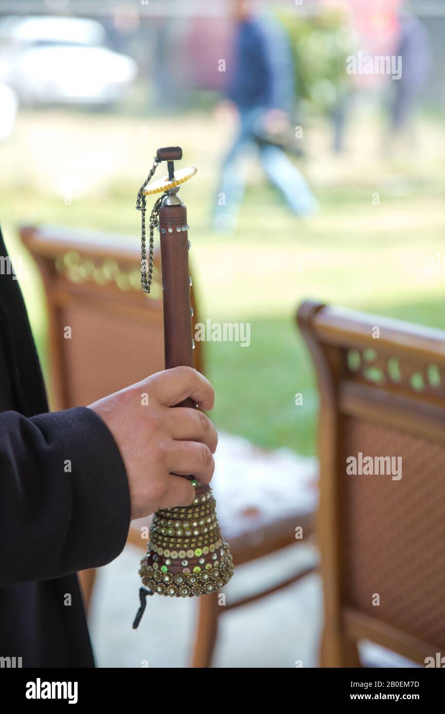 The man was holding a zurna in his hand . A man playing zurna traditional instrument in wedding