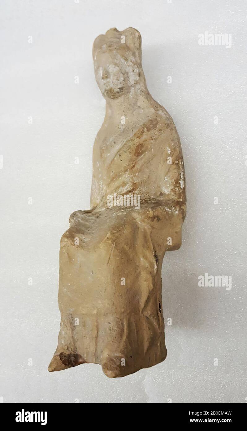South classic classic terracotta figurine of seated woman, dressed in a chiton and a himation and worked up hair., Figurine, pottery, terracotta, 13.8 cm, classic -360 Stock Photo