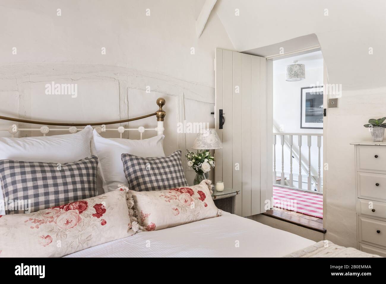 Traditional bed in cottage bedroom hires stock photography and images