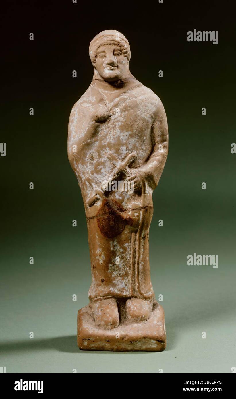 Boeotically archaic terracotta figurine of a standing man Stock Photo
