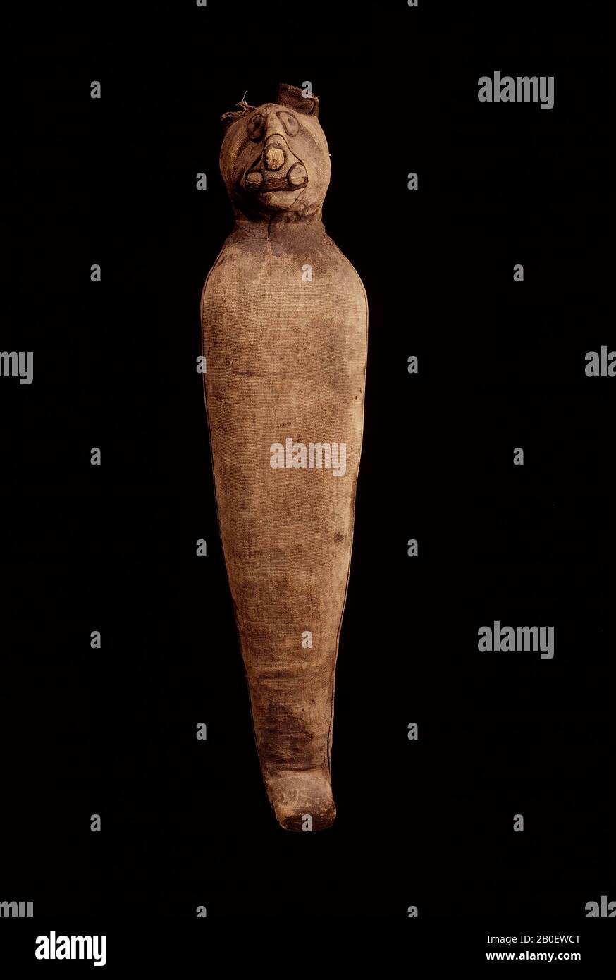 cat, Cat mummy with flattened anthropoid body tapering to protruding feet, rounded shoulders, and a naturalistic head. The front of the body is covered in a single sheet of medium-fine linen (warp-faced tabby weave, about 11 x 28 threads Stock Photo