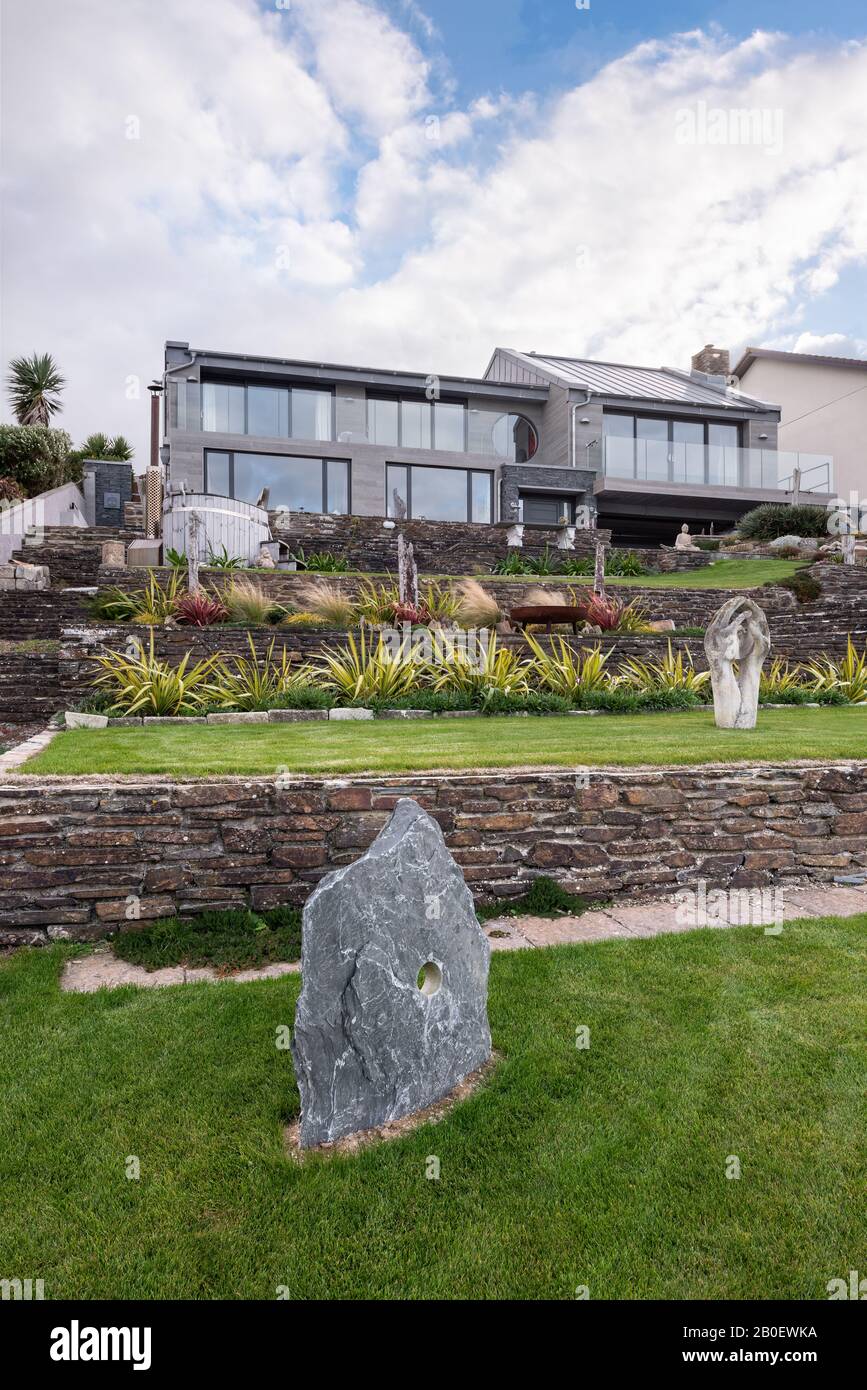 Statues in terraced garden of renovated 1960s property in Fistral, Newquay Stock Photo