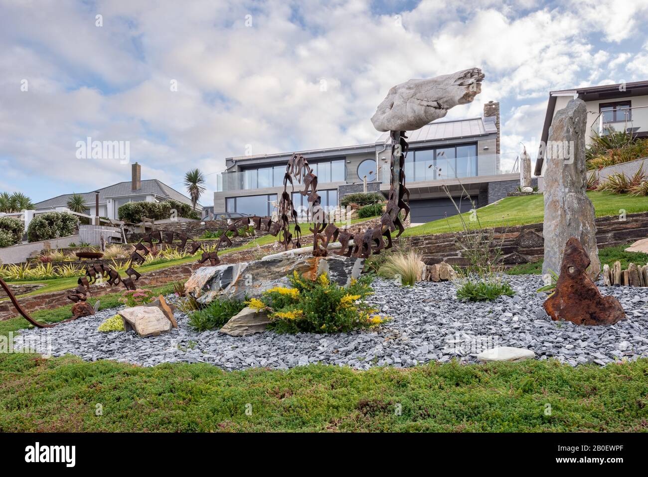 Statues in terraced garden of renovated 1960s property in Fistral, Newquay Stock Photo