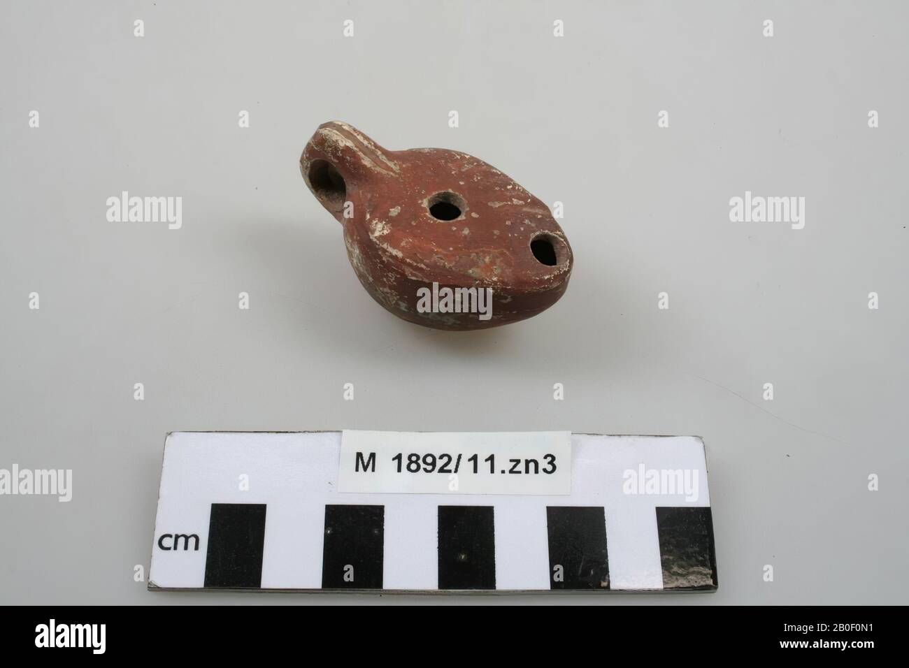 Pottery oil lamp, with ear, semi-spout, filler hole and burner hole, oil lamp, earthenware, 6 x 3.3 x 3.3 cm, Germany Stock Photo
