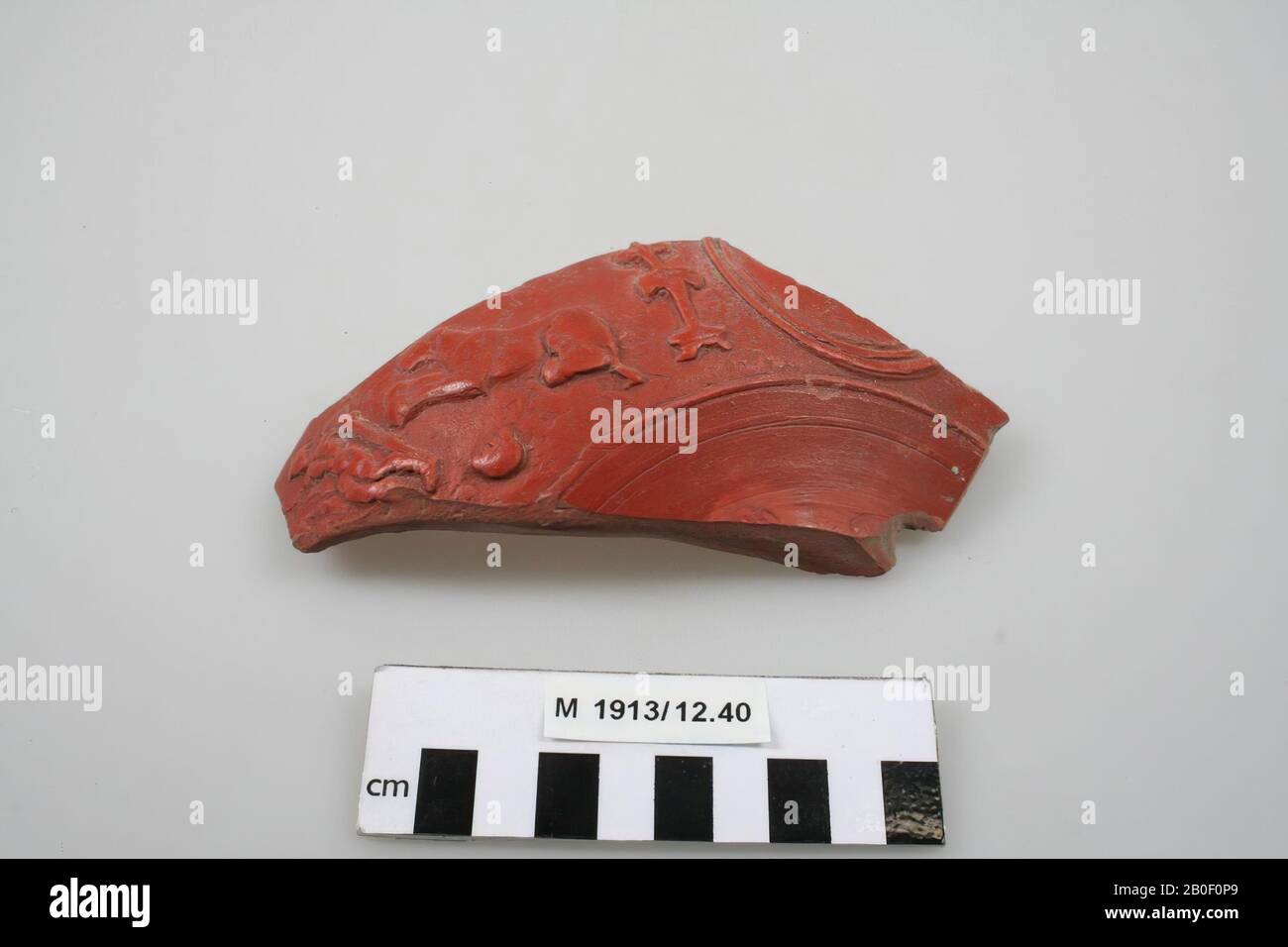 Fragment of a terra sigillata bowl: part of the bottom and part of the wall, with an image of a figure and an animal., Bowl, shard, earthenware, terra sigillata, 15 x 7 x 4 cm, roman , Germany, unknown, unknown, Rheinzabern Stock Photo