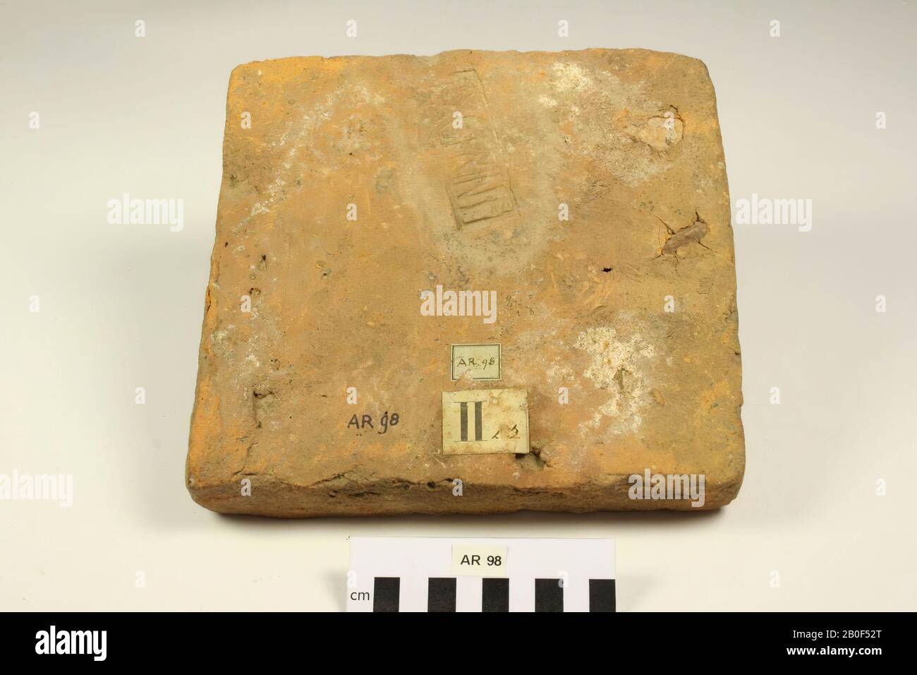 Later of brick with stamp EXGERINF. Some surface cracks due to a layered silica. Mortar residues on the surface., Later, brick, earthenware, brick, 22 x 20,8 x 4 cm, roman, Netherlands, South Holland, Leidschendam-Voorburg, Voorburg, Arentsburg Stock Photo