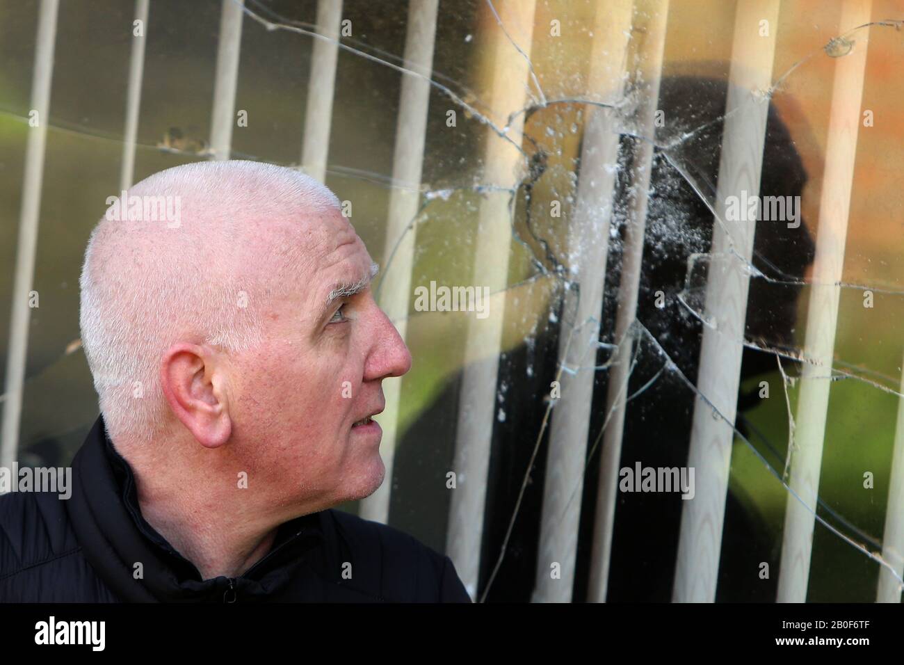 Belfast, Northern Ireland. 20th Feb 2020. Martin Finucane, brother of the murdered solicitor Pat Finucane, stands outside his home in Lenadoon moments after a explosive device was thrown at his home in west Belfast. Martin is the Uncle of North Belfast Sinn Fein MP John Finucane. Credit: Irish Eye/Alamy Live News Stock Photo