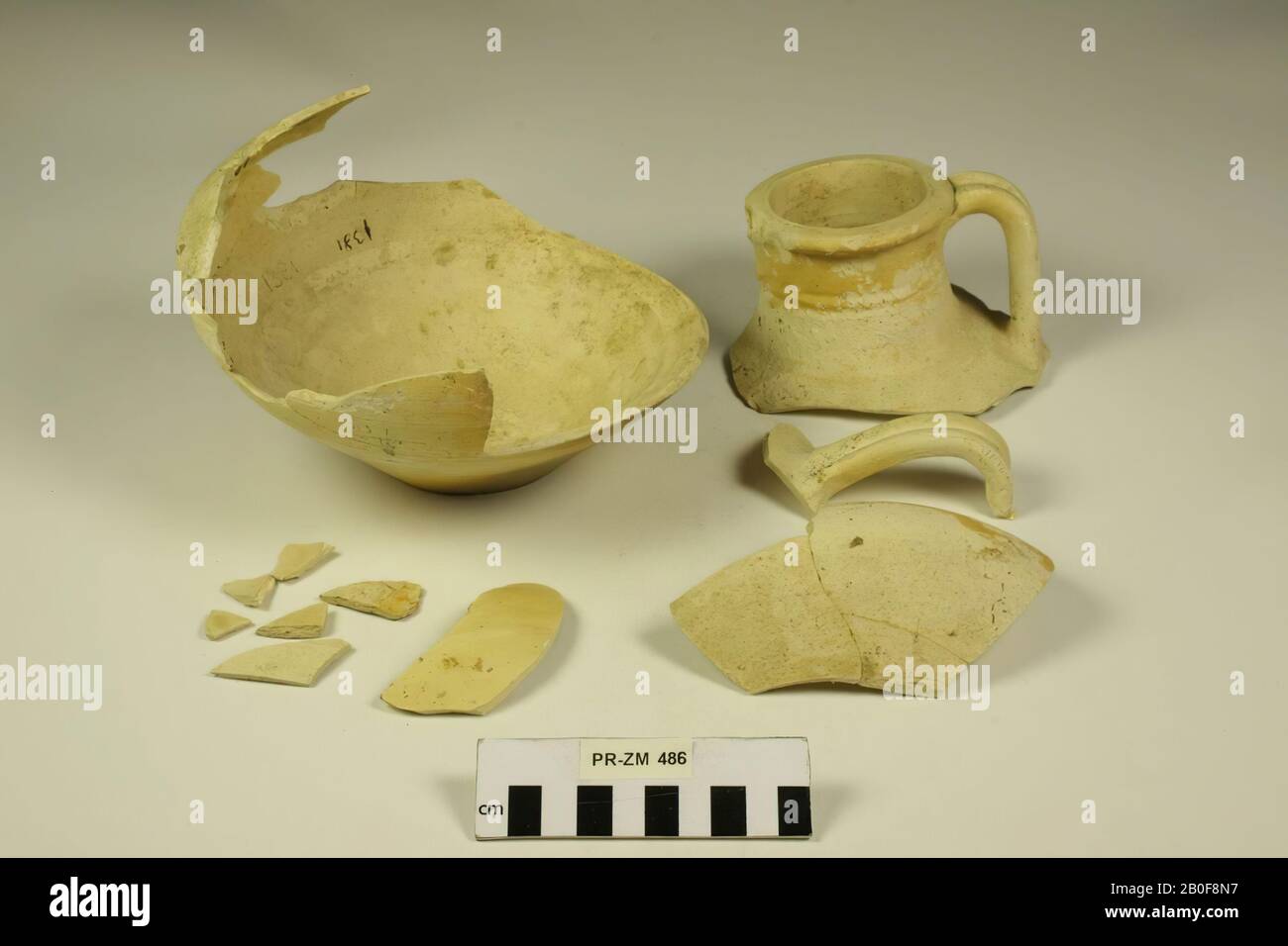 Jug of white pipe earth, large parts in the wall are missing. It consists of 4 large parts: 2 abdominal fragments, 1 neck fragment and 1 ear fragment. In addition several loose small shards., Jar amphora, earthenware, h: 12.5 cm, diam: 20.2 cm, roman, Netherlands, unknown, unknown, unknown Stock Photo